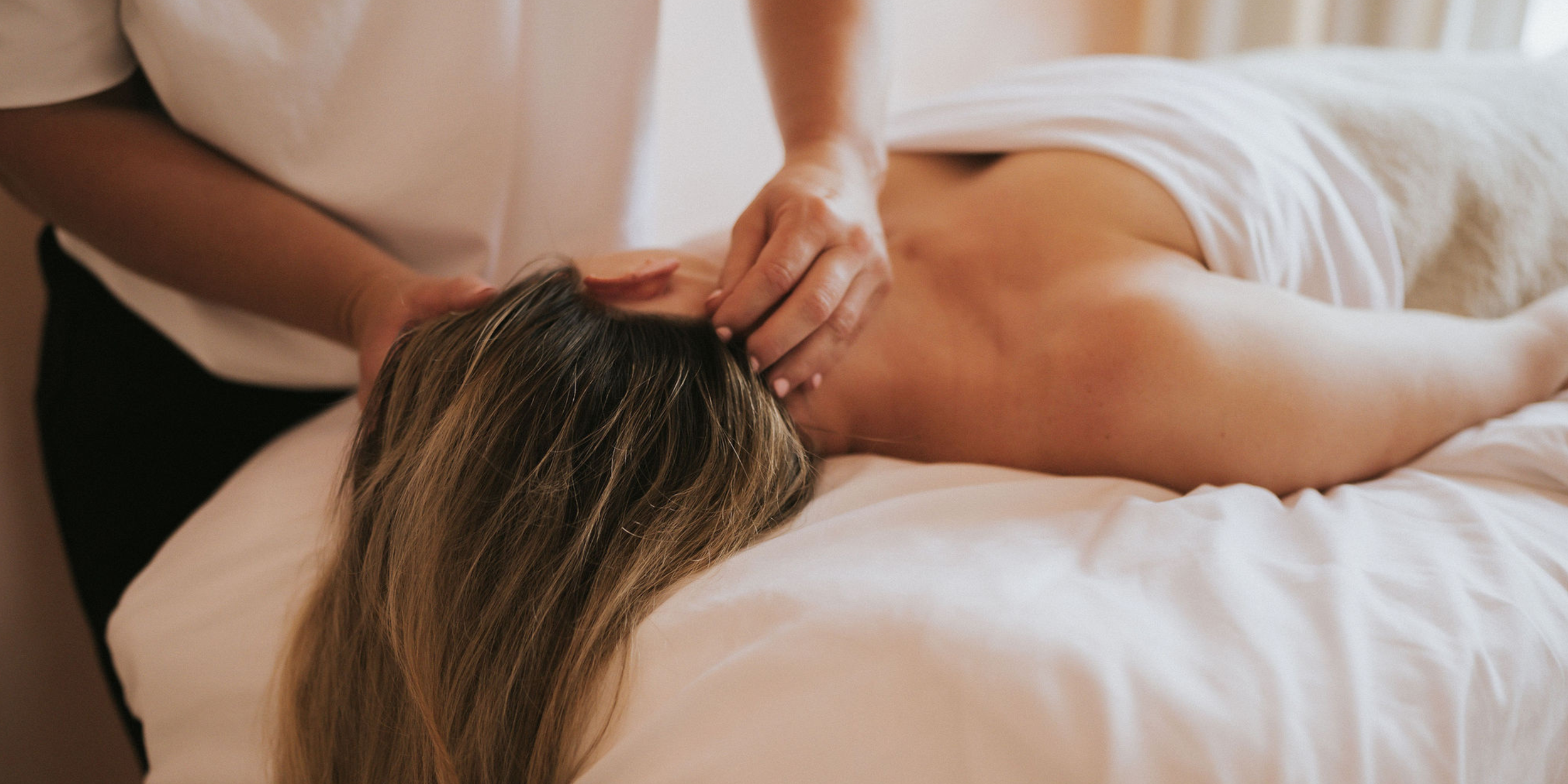 Close-up of a relaxed face during facial massage at FaceUp Studio, jaw and brow visibly softened