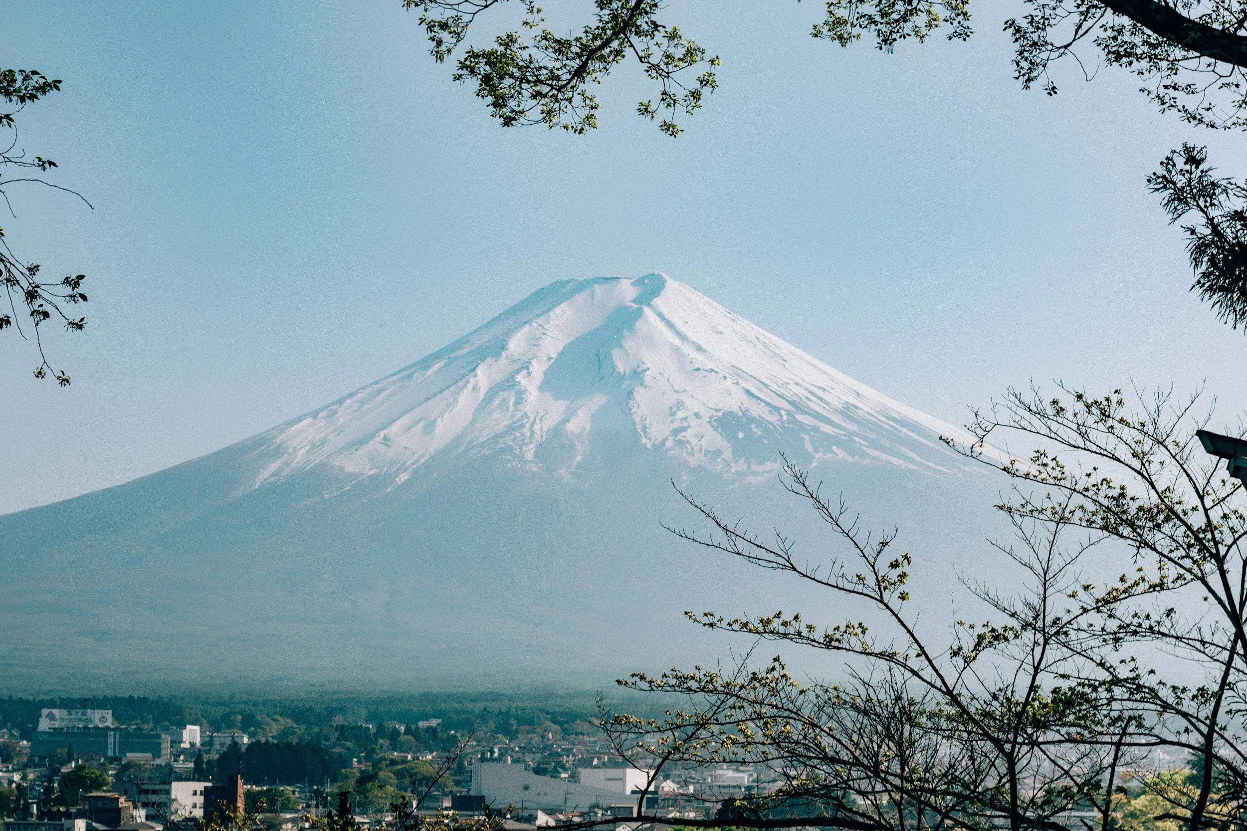 A high-altitude photograph of Japan with Mount Fuji as the focal point