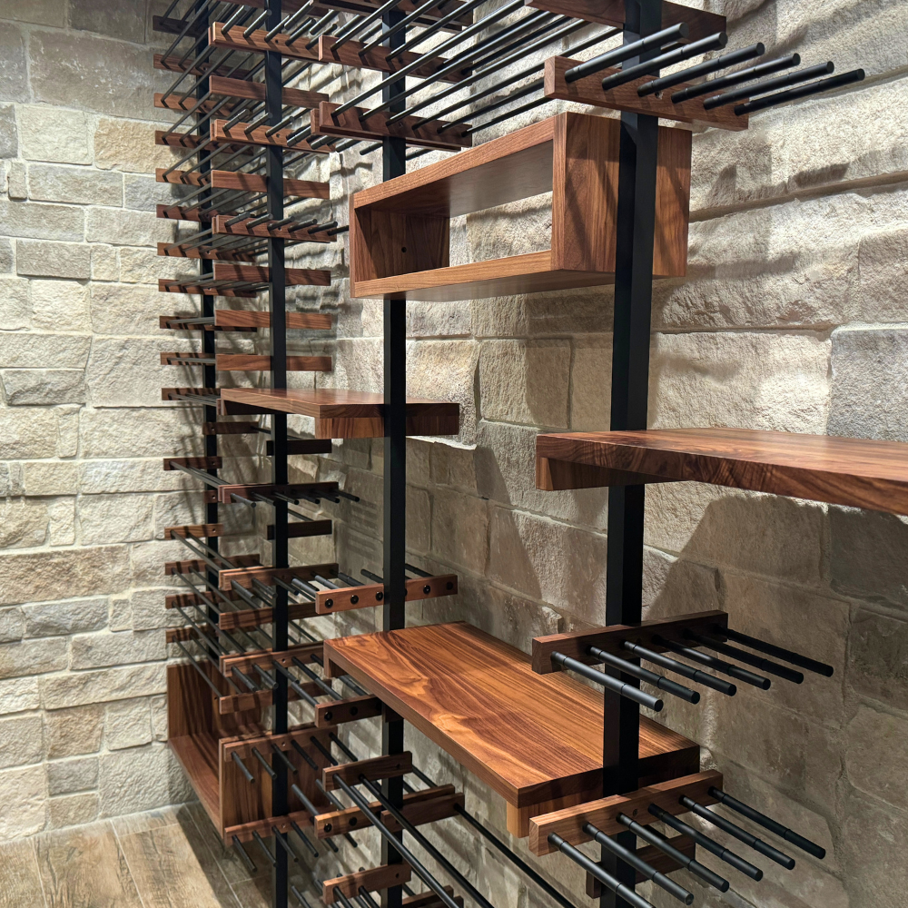 Wooden and metal wine storage rack mounted on a stone wall with multiple shelves and slots for bottles.