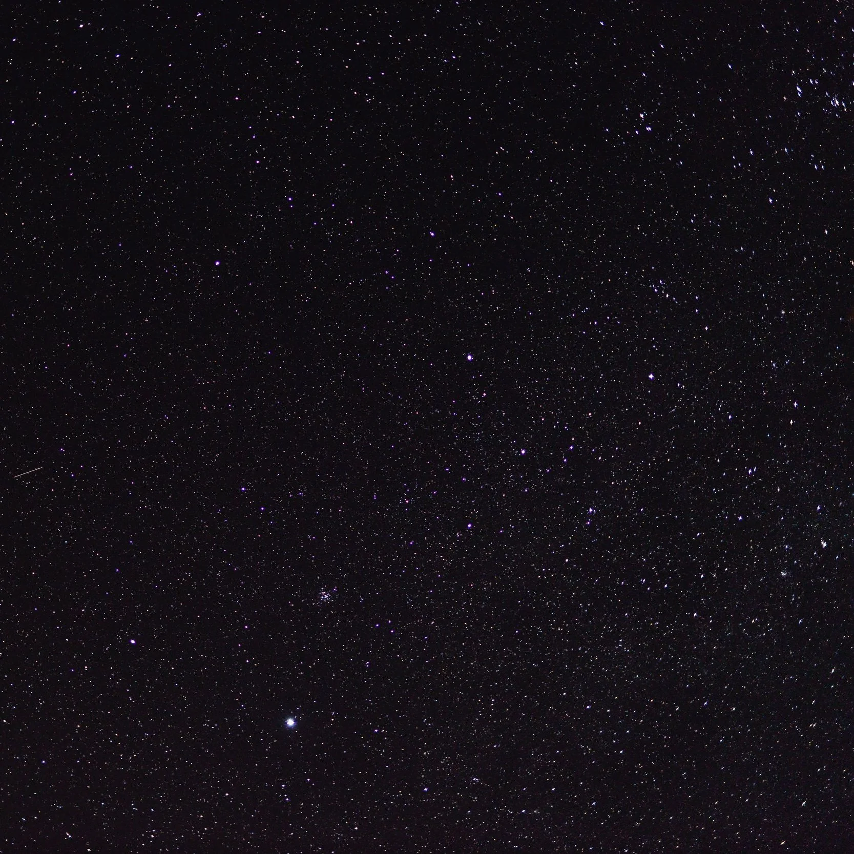 A clear night sky filled with numerous stars and some visible constellations.
