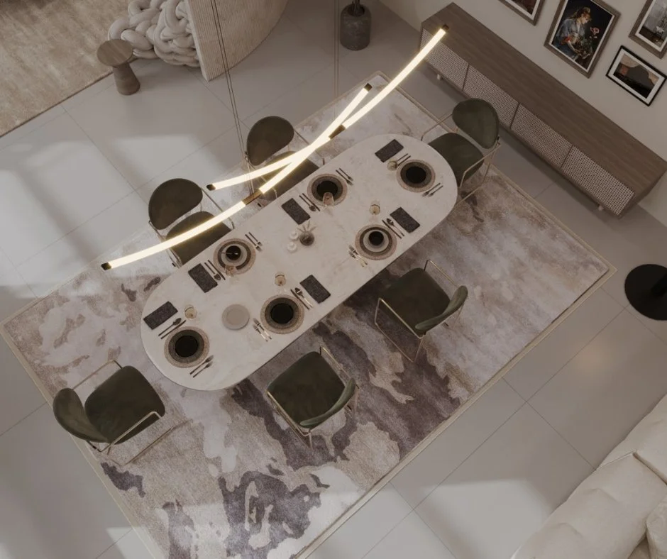 Vista aérea de una mesa de comedor ovalada con ocho sillas verdes, un decorativo intrincado y lámpara moderna suspendida sobre la mesa en una sala moderna con cuadros en la pared.