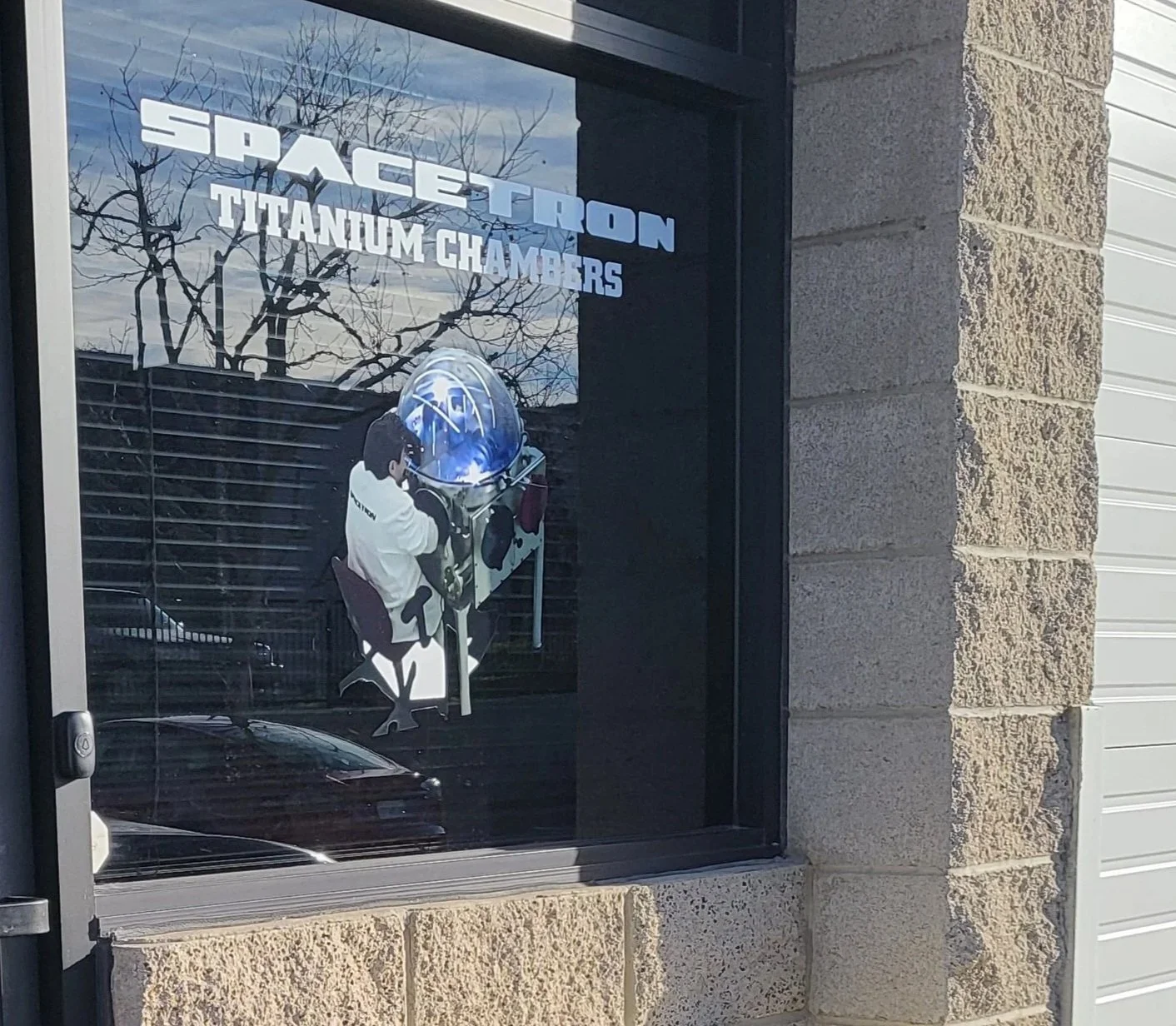 Spacetron Titanium Chambers Co. company signage for facility located in Valencia, CA.