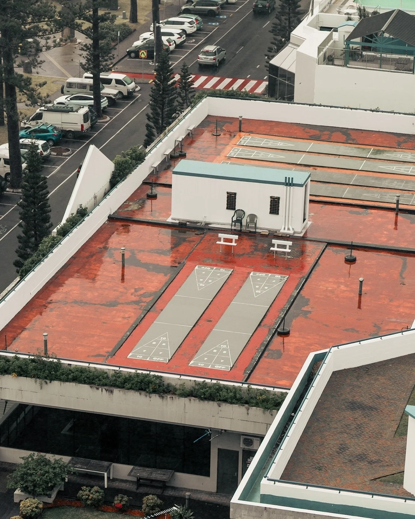 This rooftop series was one of my favourites to shoot in Coolangatta. Simple details, soft light, and just the right amount of symmetry. Curious which one speaks to you more &mdash; the shuffleboard court, the stacked picnic benches, or that bold con
