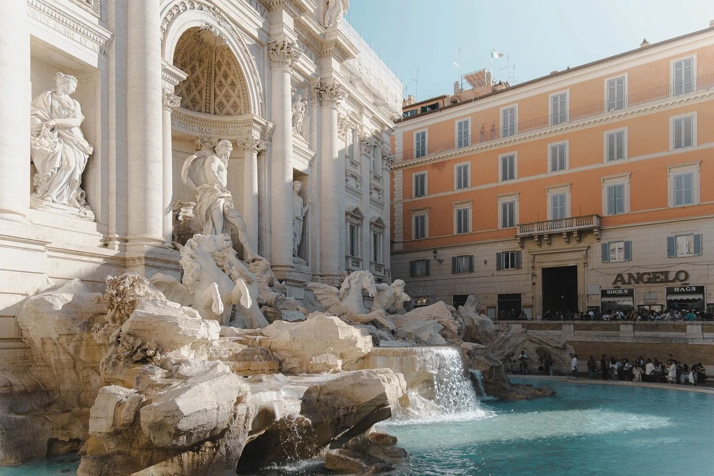 TREVI FOUNTAIN ⛲️ 

We couldn&rsquo;t visit the city of Rome without stopping by to admire the famous Trevi Fountain. What an incredible structure! 
I love the way the orange building contrasts with the azure water in the fountain in this shot. I can
