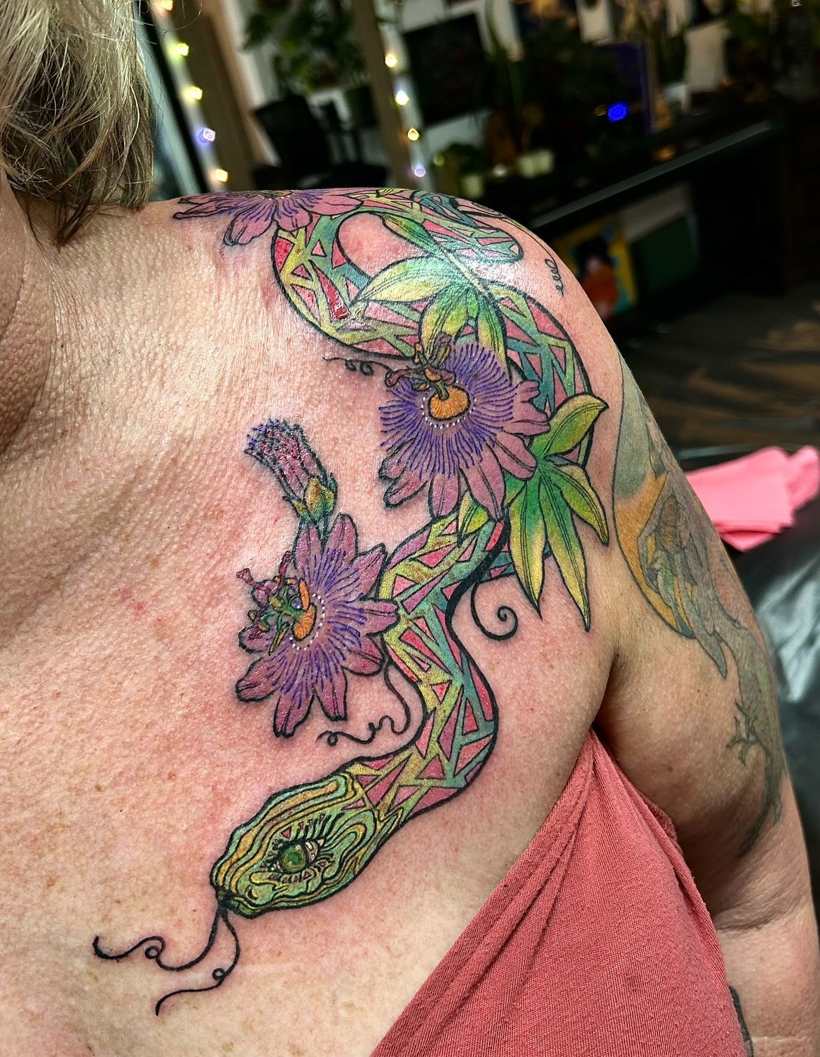 A colorful tattoo of a snake by Arville Persons