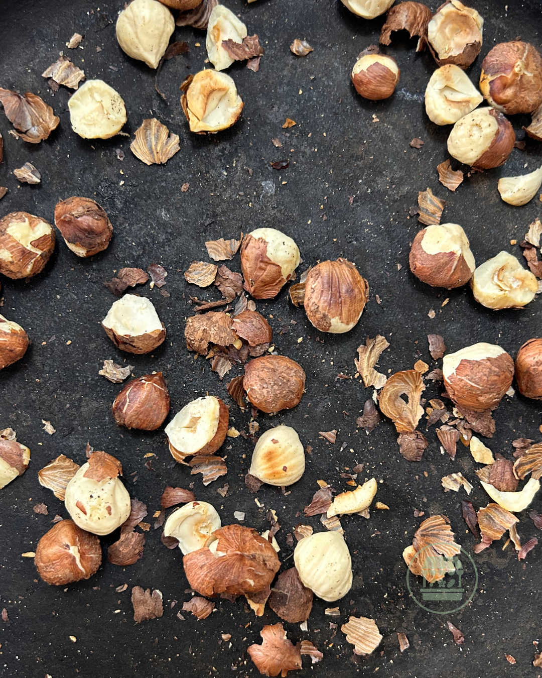 Toasting raw hazelnuts in a cast iron pan.png