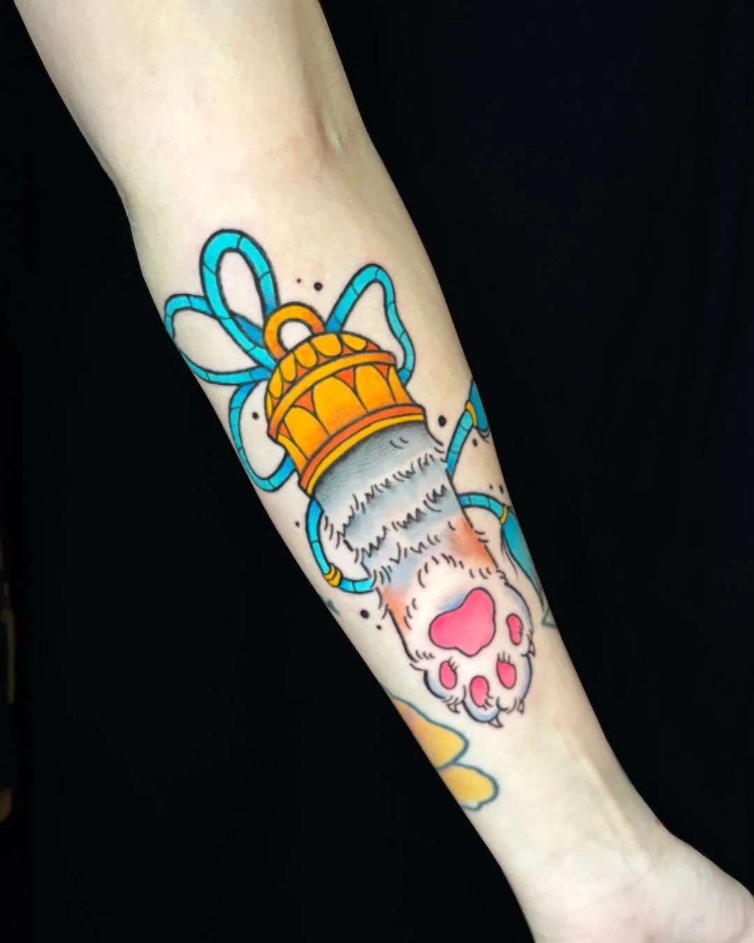 Neotraditional kitten paw tattoo, tattooed in West Palm Beach, Florida. This custom neotraditional design features a cat paw emerging from a decorative cuff, symbolizing affection, protection, and love for animals. Bold outlines, vibrant colors, and 