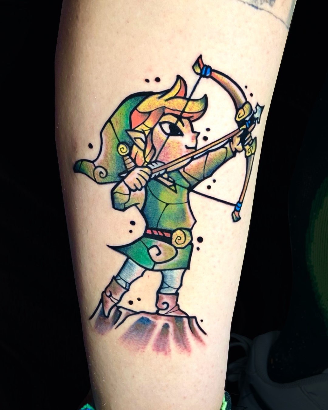 Anime tattoo inspired by The Legend of Zelda, tattooed in West Palm Beach, Florida. This colorful piece features Link, the legendary hero of Hyrule, depicted in an archer pose that symbolizes courage, precision, and adventure. The design blends clean