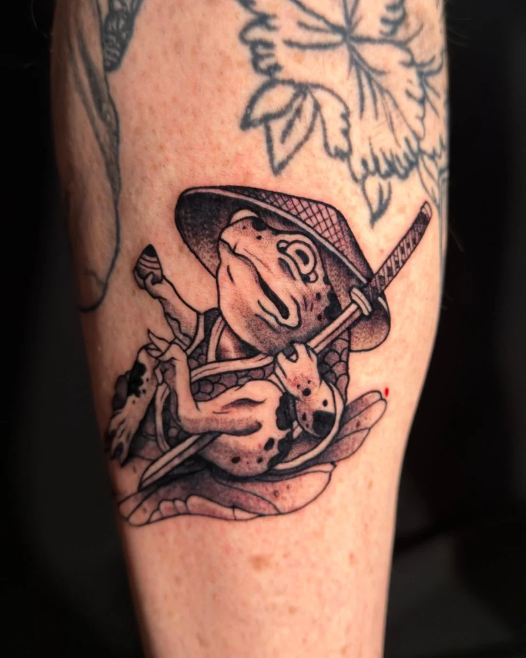 Traditional Japanese frog tattoo done in West Palm Beach, Florida. This custom tattoo features a classic Japanese frog (Kaeru), designed with bold outlines, strong contrast, and clean linework inspired by traditional Japanese tattoo art. Tattooed by 