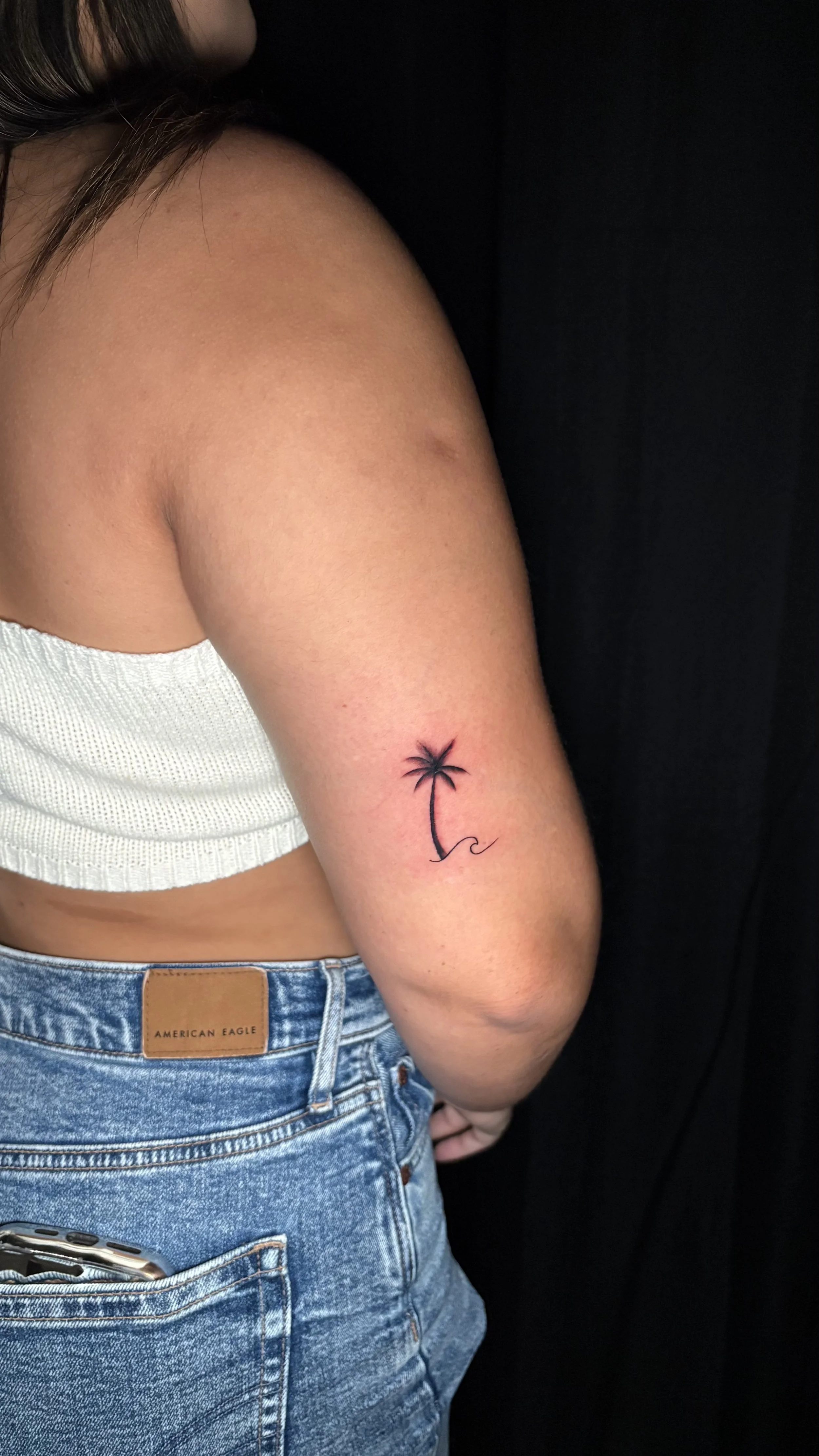 Fine line palm tree tattoo with minimalist linework, tattooed on the arm by Flow Kappa in West Palm Beach, Florida.