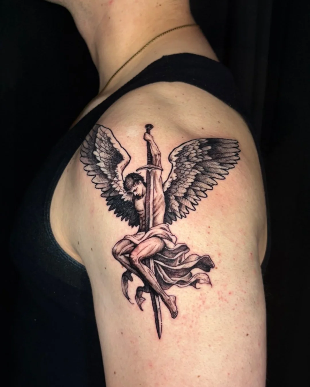 Angel blackwork tattoo created in West Palm Beach, Florida. This piece features a winged angel pierced by a sword, symbolizing sacrifice, protection, and inner struggle. Executed entirely in blackwork, the design focuses on fine linework, contrast, a