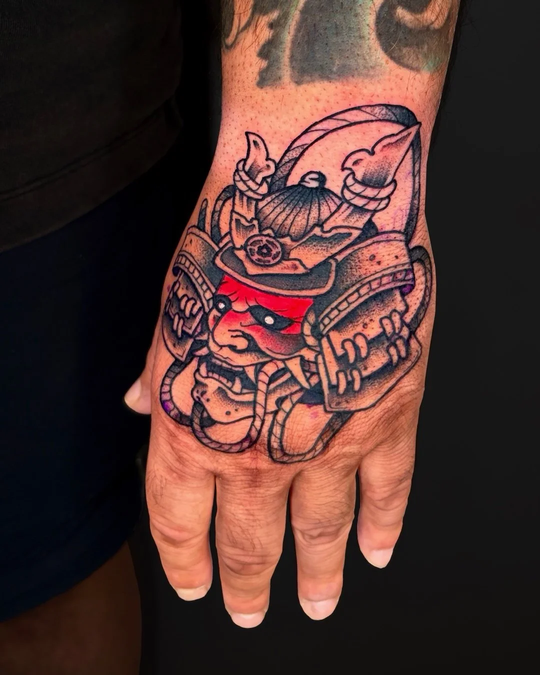 Traditional Japanese Oni samurai mask tattoo done in West Palm Beach, Florida. This custom tattoo features a classic Oni mask inspired by samurai armor (menpō), designed with bold outlines, strong contrast, and dynamic detail true to traditional Japa