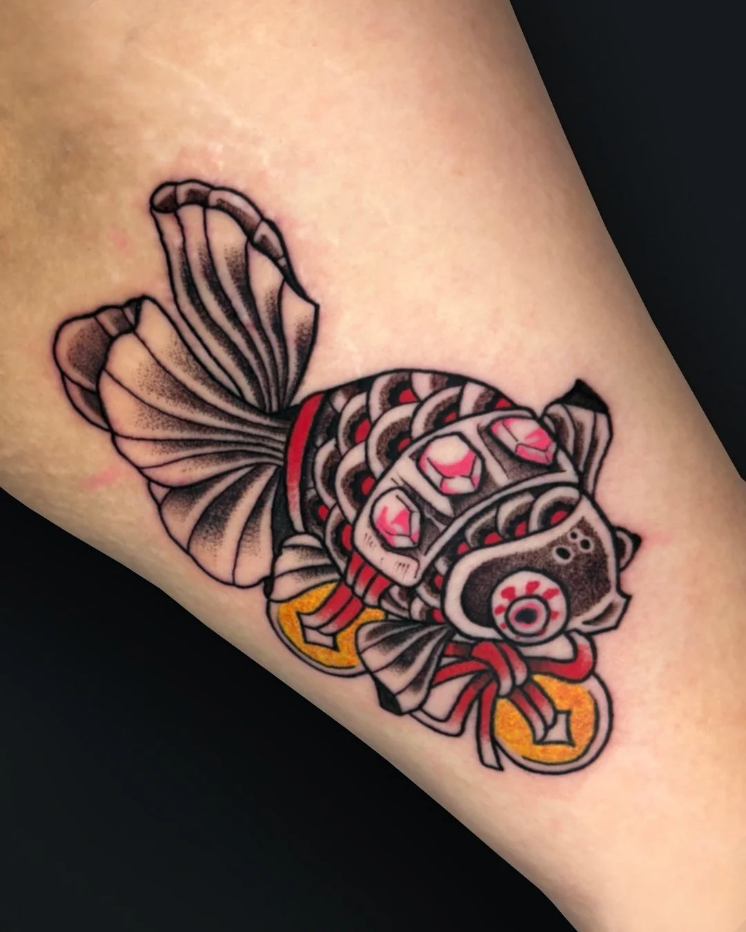 Japanese Traditional fish tattoo in West Palm Beach, Florida, inspired by classic Irezumi symbolism and executed with bold black linework, soft shading, and controlled color accents. In traditional Japanese tattooing, fish represent perseverance, ada