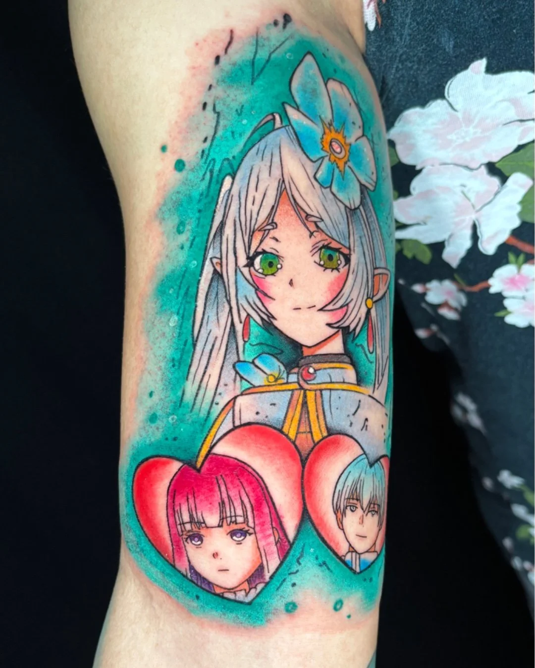 Anime tattoo inspired by Frieren: Beyond Journey’s End (Sousou no Frieren), tattooed in West Palm Beach, Florida. This colorful anime-style piece features Frieren, the elven mage, accompanied by portraits of Fern and Stark, symbolizing memory, bonds,