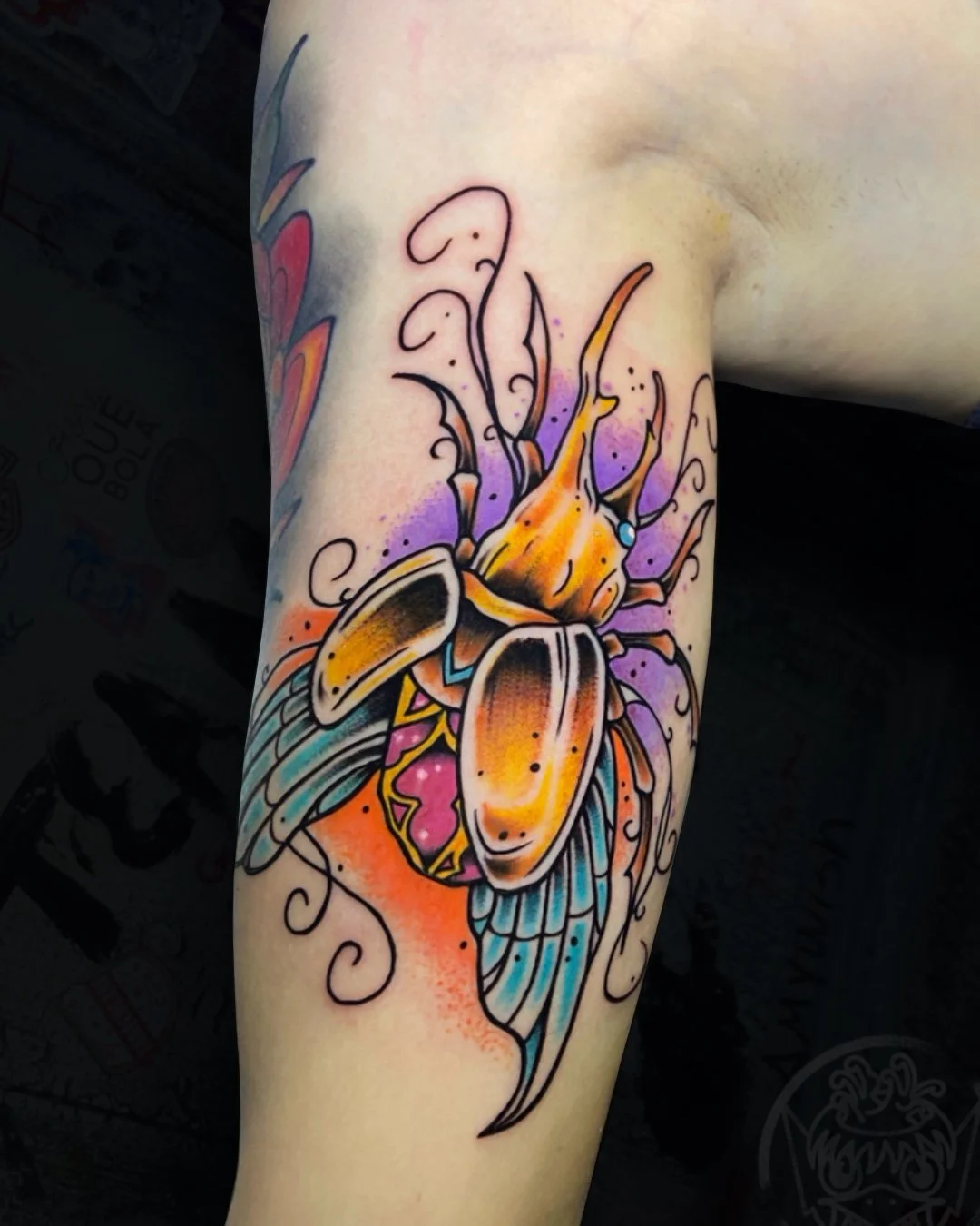 Neo-traditional Egyptian scarab beetle tattoo with bold colors and detailed linework on the upper arm, tattooed by Flow Kappa in West Palm Beach, Florida.