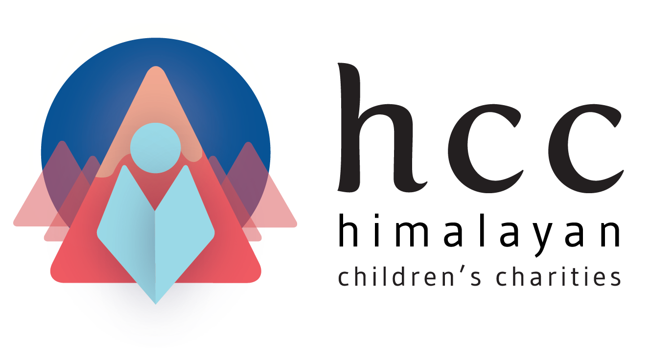 A colorful logo with geometric mountain shapes, a circle, and triangles, accompanied by the text 'hcc himalayan children's charities'.