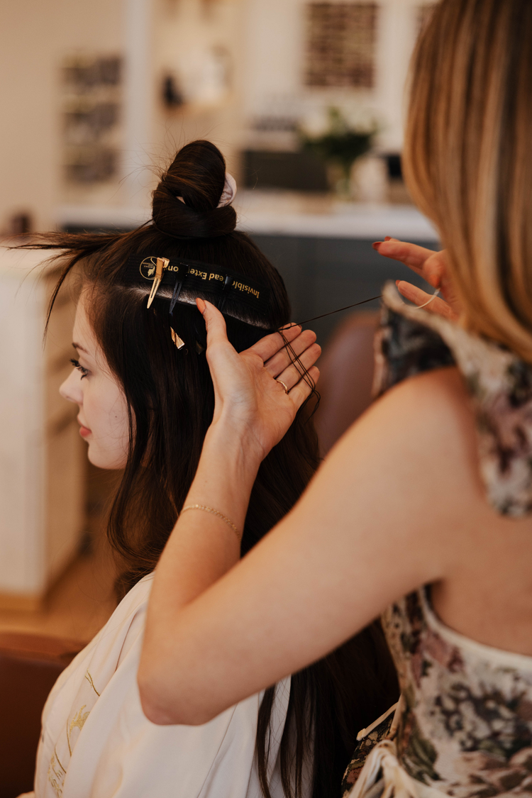 Hairdresser braiding a client's hair