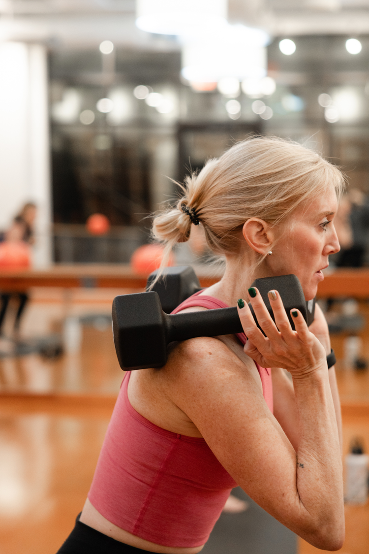 Woman lifting a dumbbell in a gym