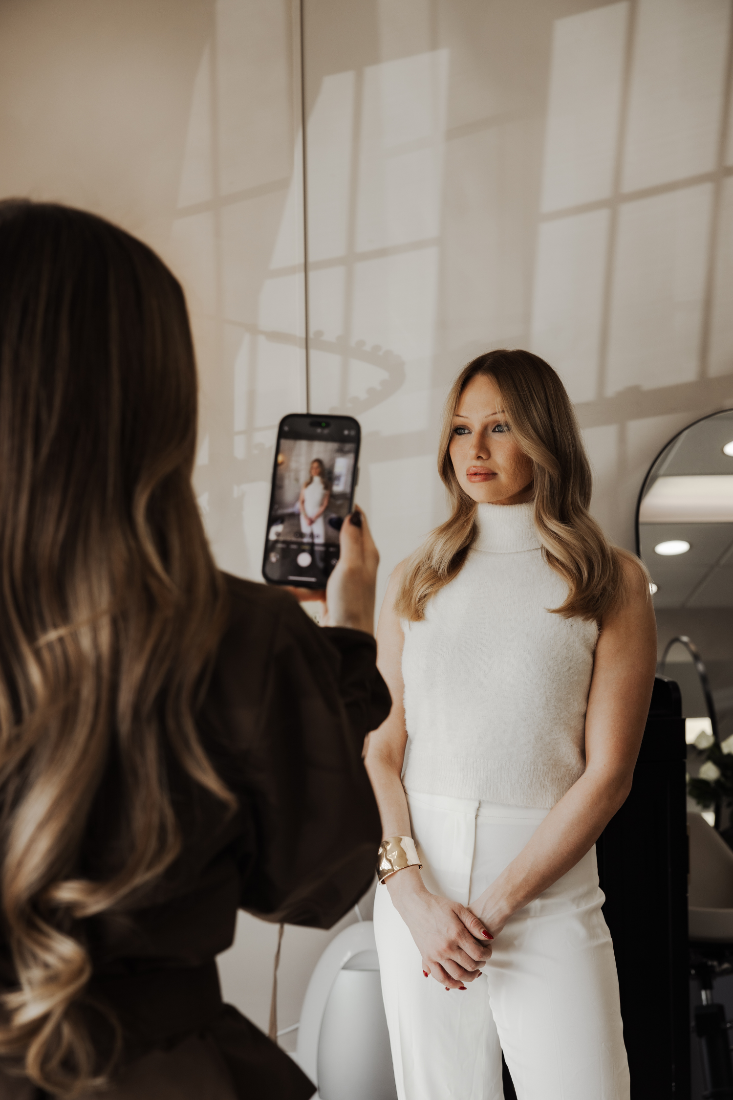 Photographer shooting a model in front of a mirrored wall