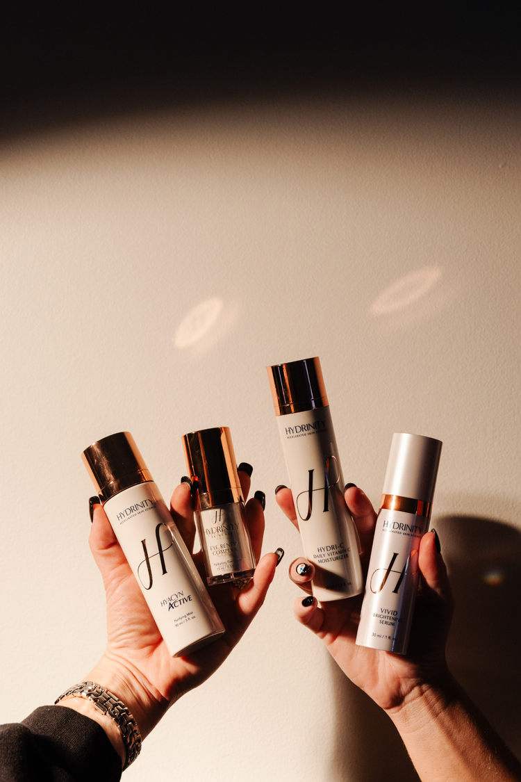 Hands holding skincare products