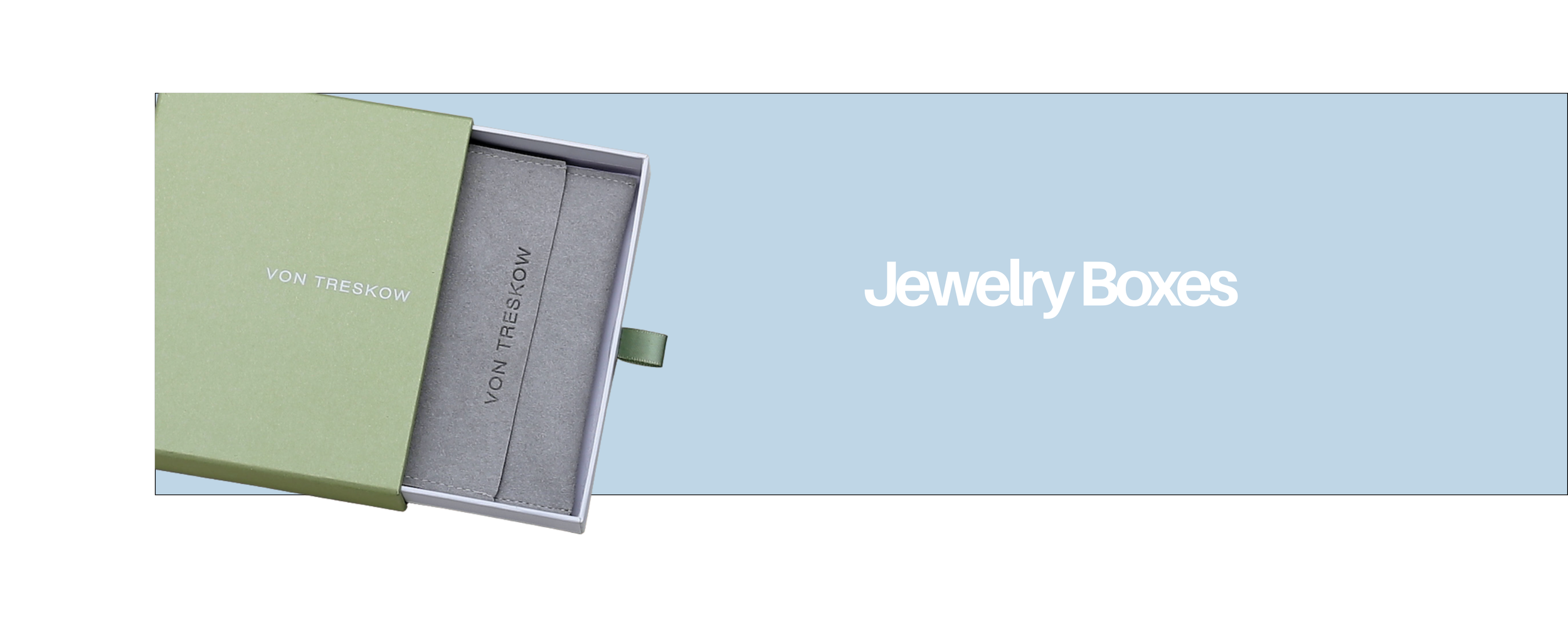 Open jewelry box with a green cover, showing gray interior with slides labeled 'VON TRESKOW'; background is light blue and white text reads 'Jewelry Boxes'.