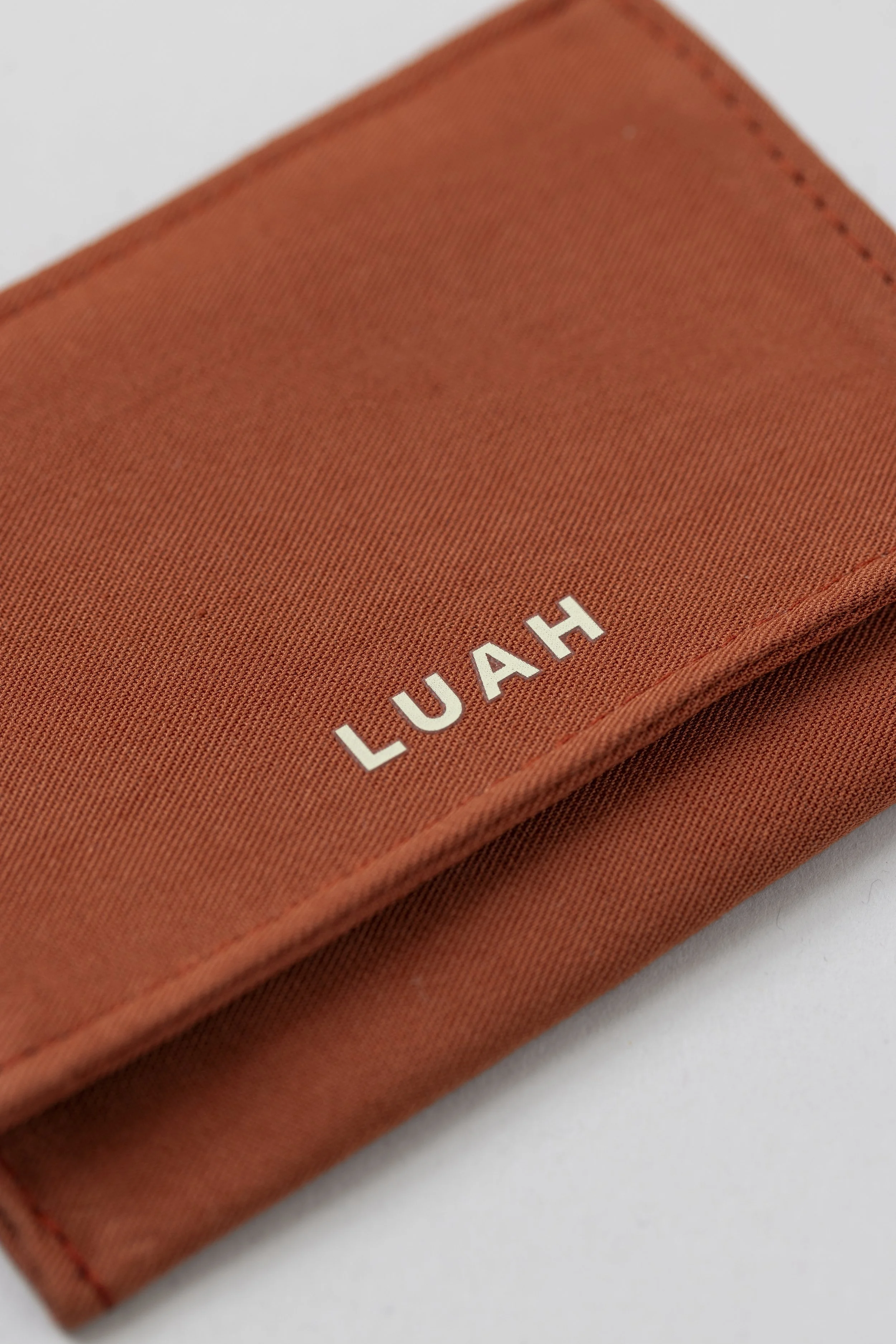 Jewellery pouch made from bamboo with brand name 'LUAH' in white letters on the corner.