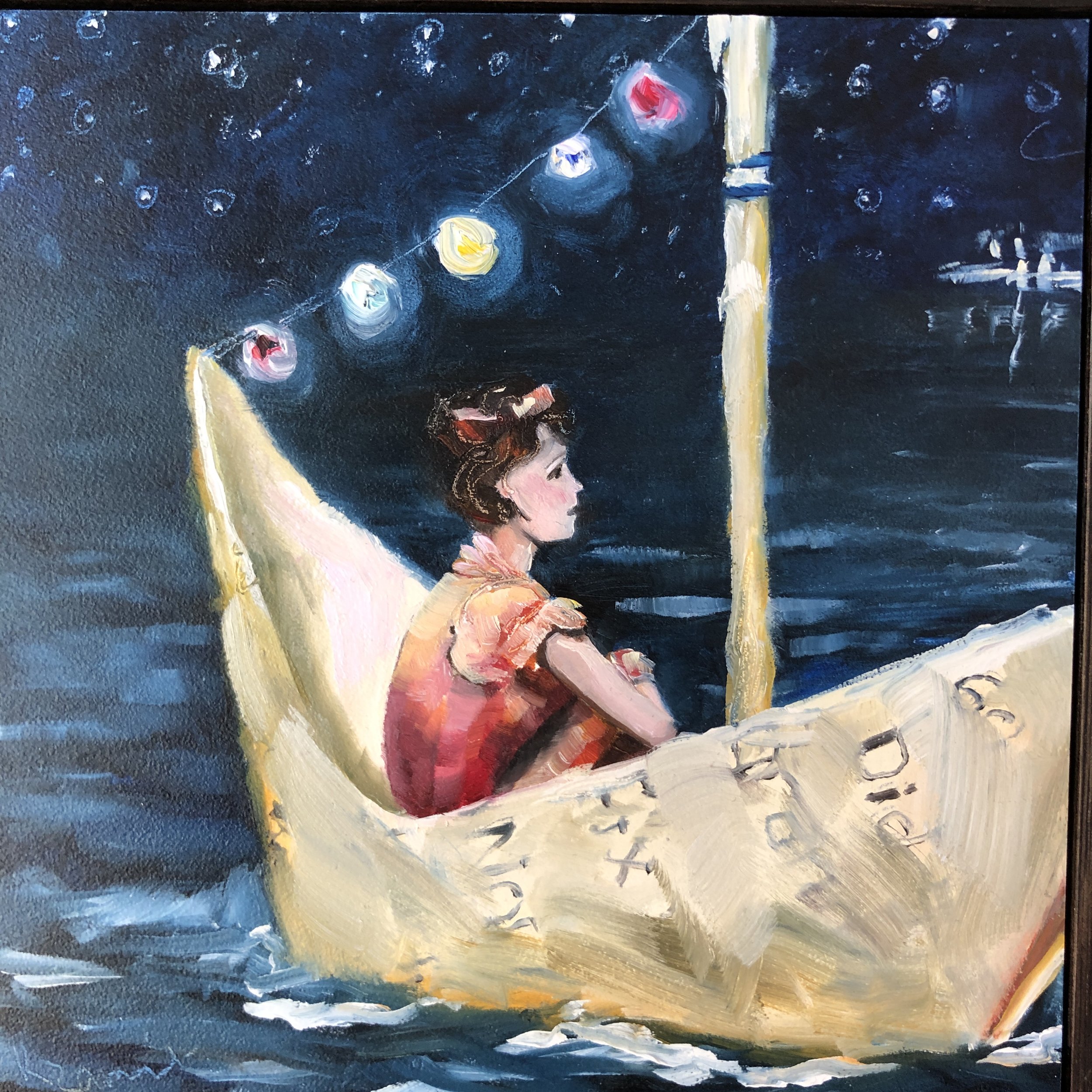 This is a dreamy little painting featuring a paper boat and her passenger.  There is a string of coloured lights and the sky is full of stars.  Not lost at sea but happy floating where the current takes her