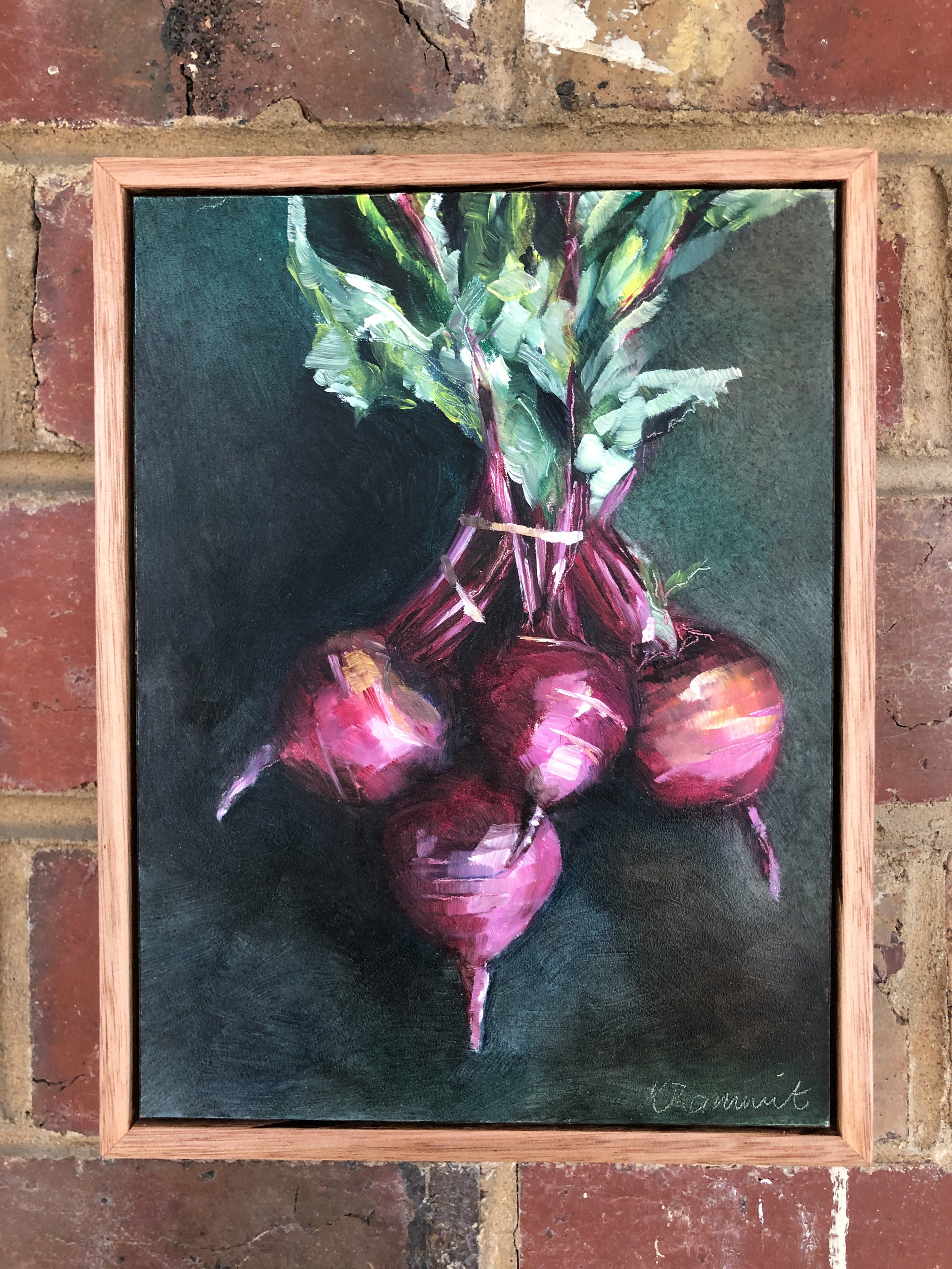 This still life of beetroot captures the warm reds and purple tones in the bulbs and stems and the contrast green of the leaves.  It is quite a dramatic little piece and is beautifully framed in oak which contrasts with the black background
