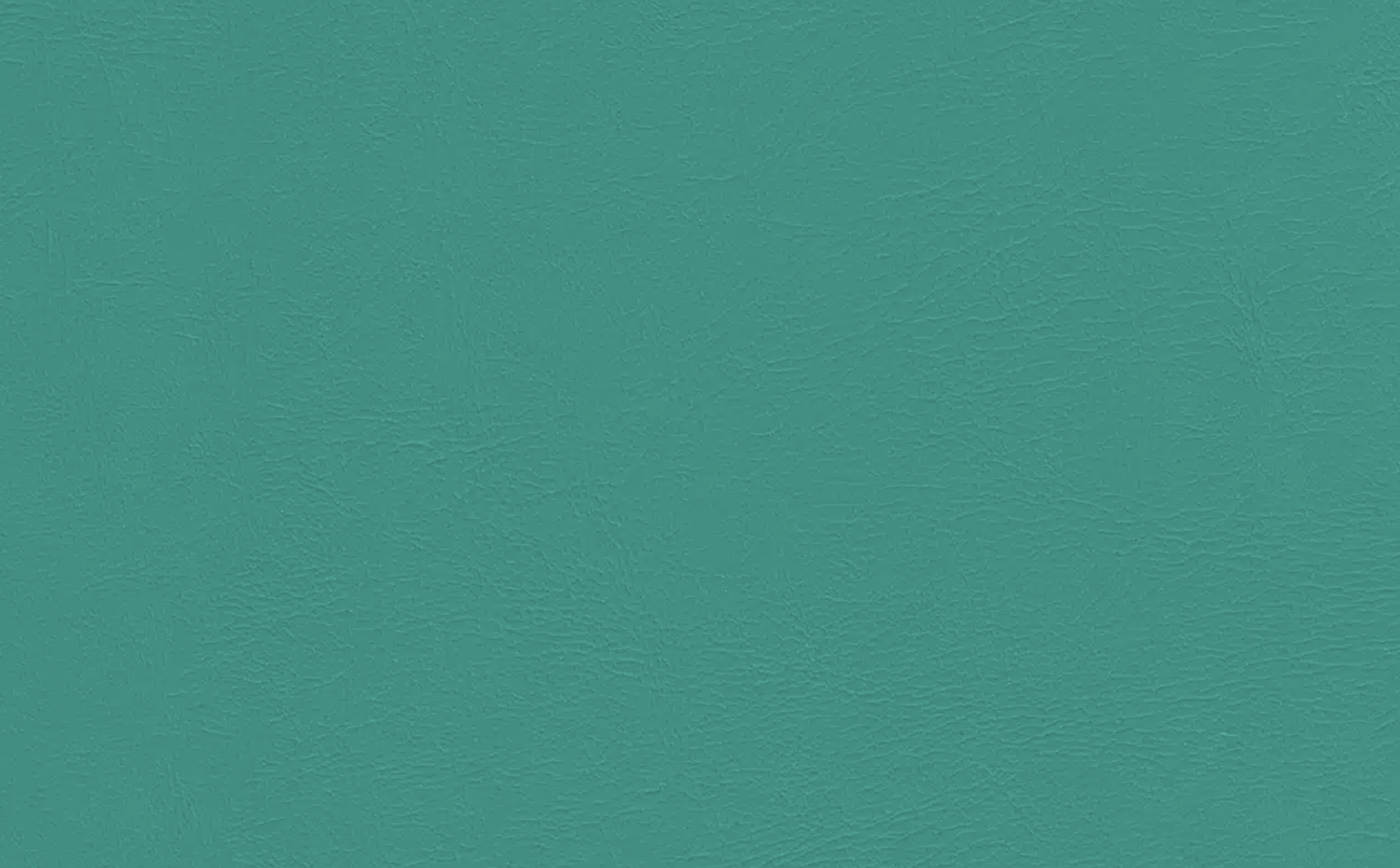 Close-up of teal-colored leather surface with textured grain.