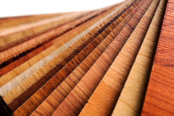 Close-up of various wooden planks in different shades of brown, arranged in a row.