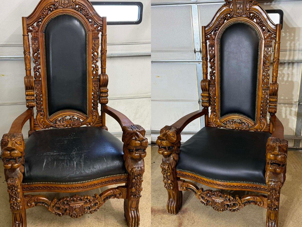 Two ornate wooden armchairs with carved lion head armrests and detailed backrest designs, upholstered with black leather on the seat and back.
