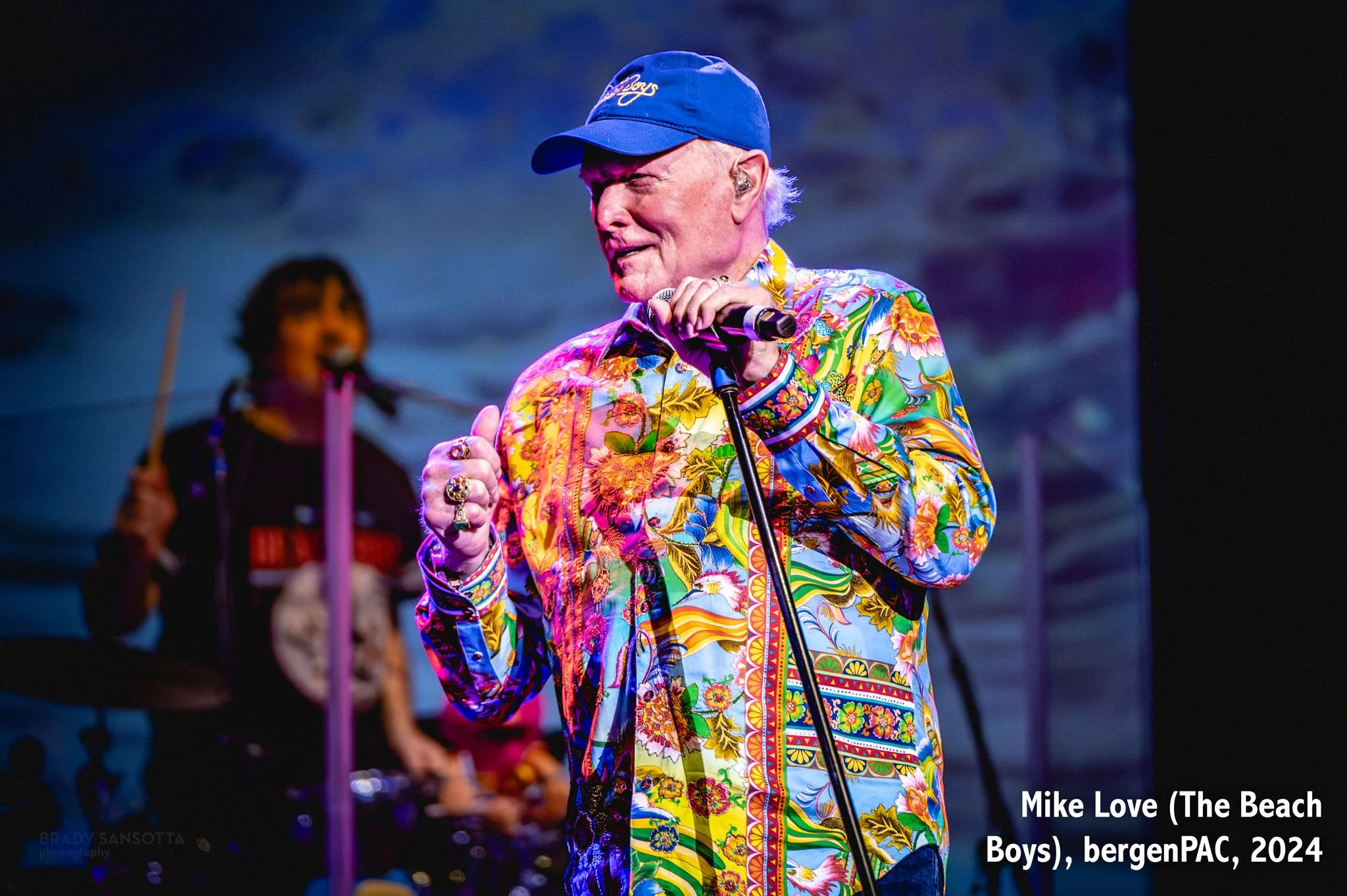 Mike Love of the Beach Boys singing and smiling during a surf rock concert at BergenPAC in Englewood, NJ.