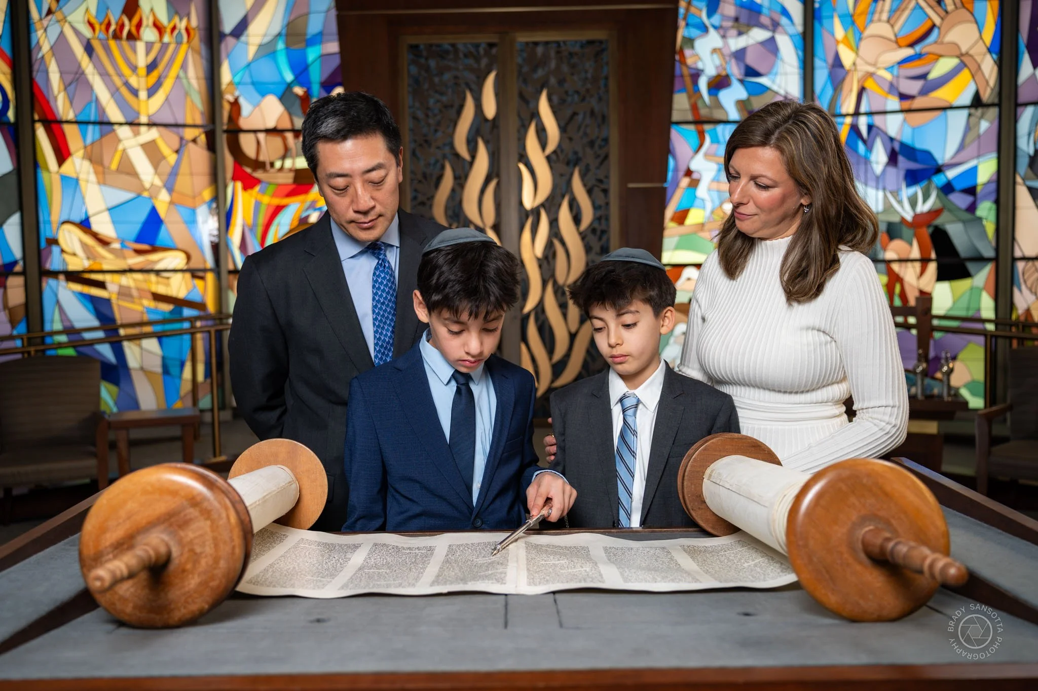 Family portraits at the Bimah with colorful stained glass backdrop at Temple Sinai in Tenafly, NJ.