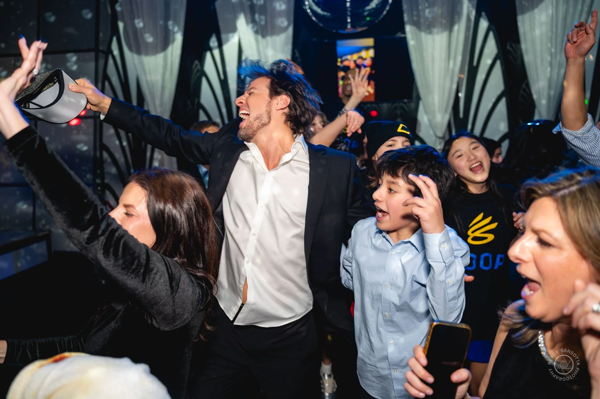 Action shot of dancing at a Bar Mitzvah celebration by candid event photographer in Paramus, NJ.