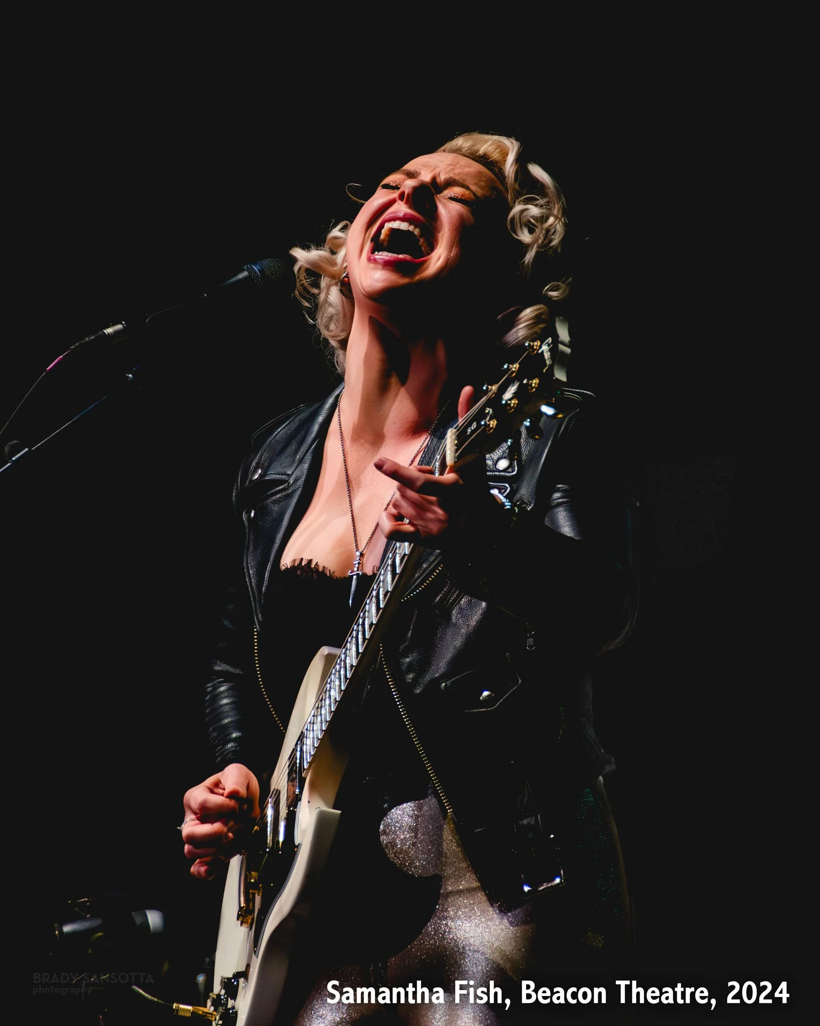 Samantha Fish performing blues-rock with guitar at the Beacon Theatre in New York City.