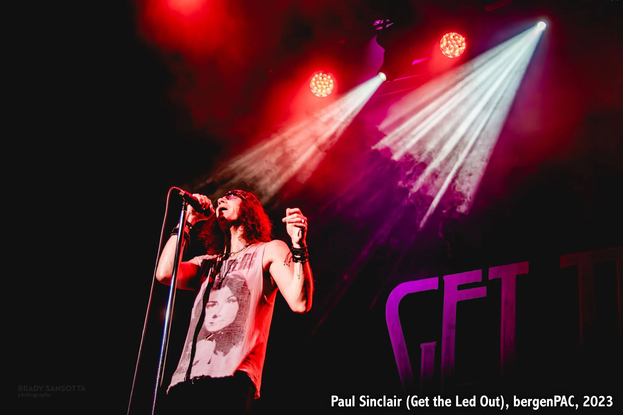 Lead singer Paul Sinclair of Get the Led Out singing under dramatic lighting at BergenPAC in Englewood, NJ.