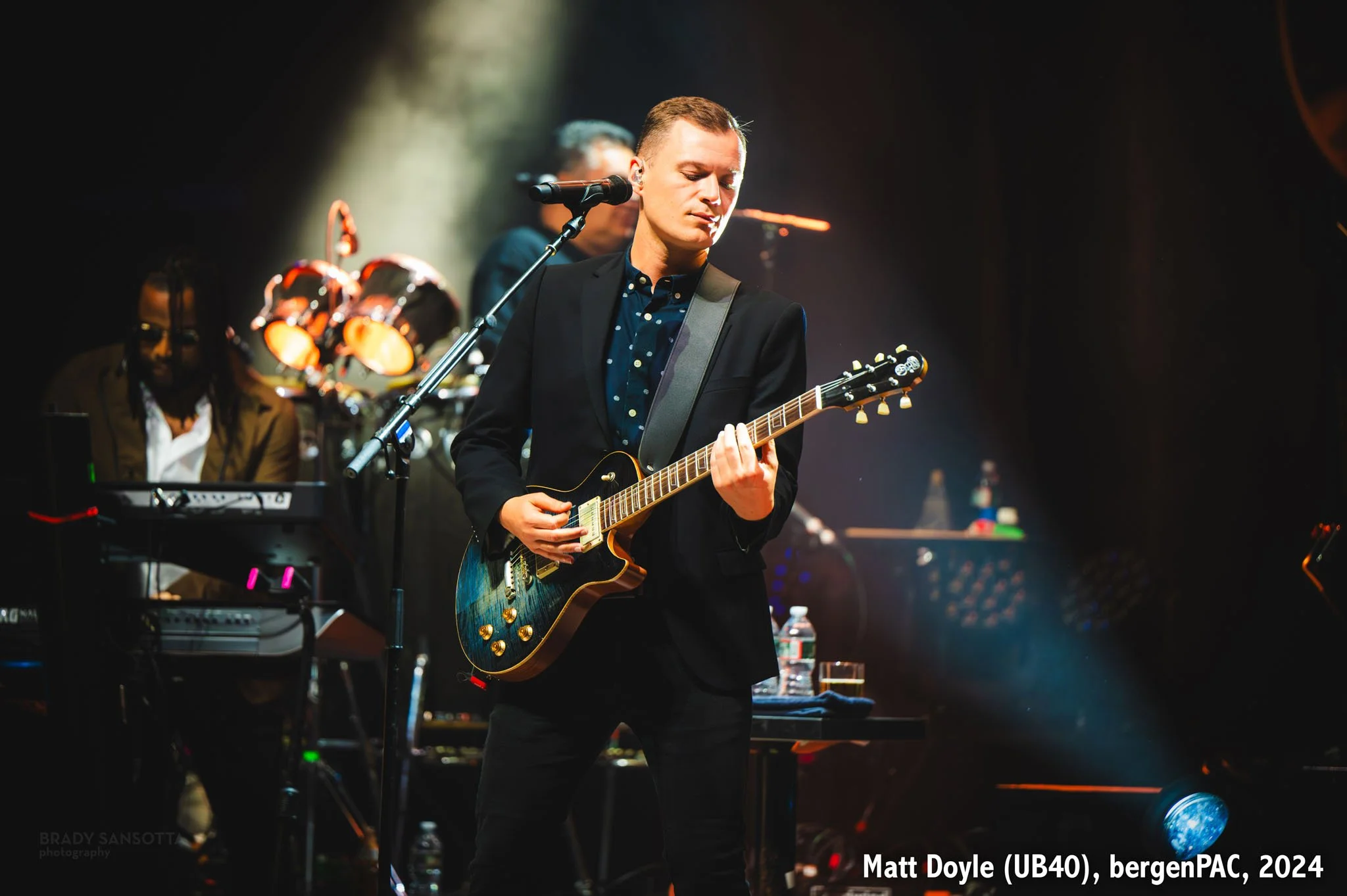 Matt Doyle of UB40 playing guitar during a reggae concert at BergenPAC in Englewood, NJ.