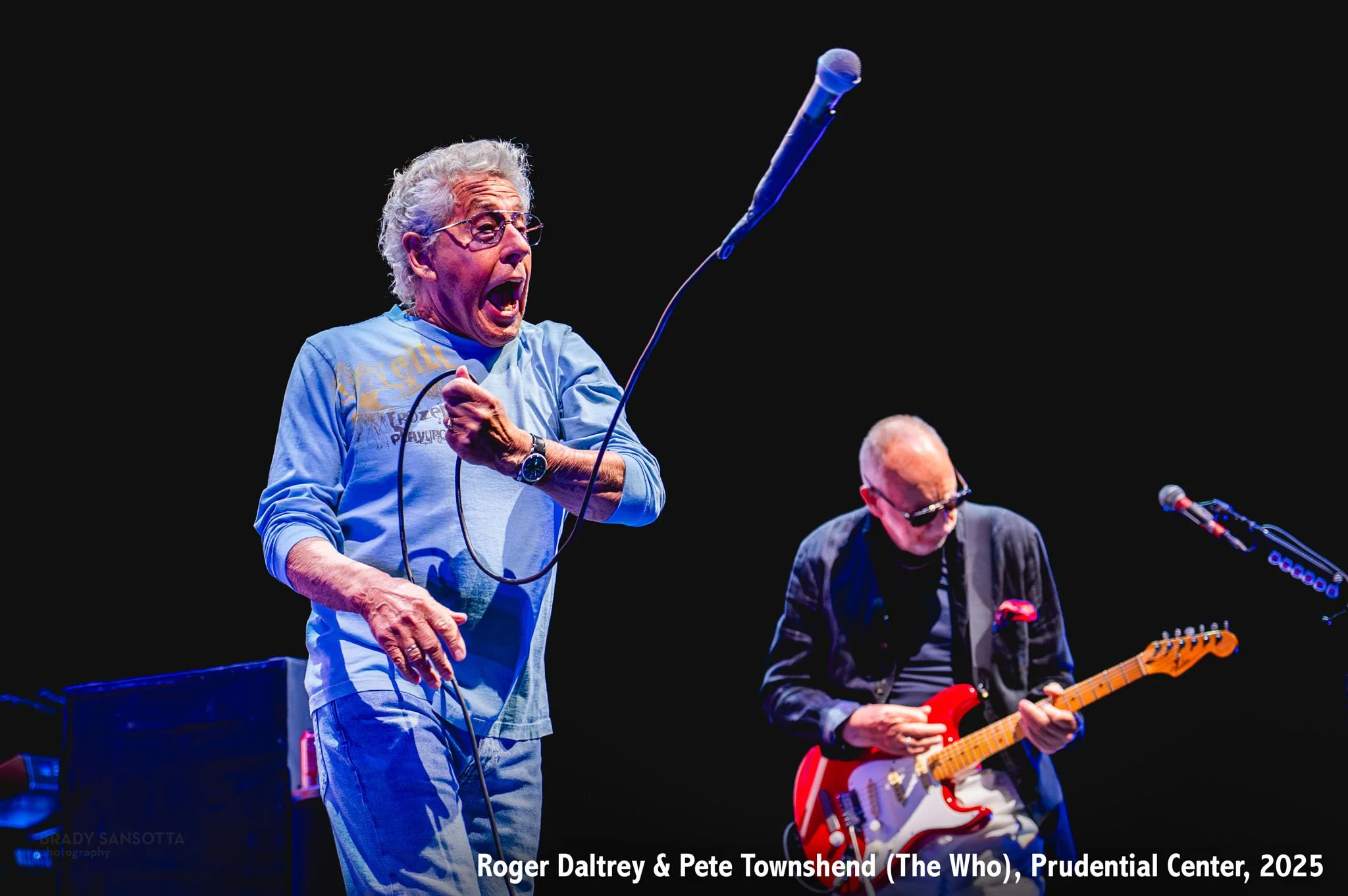 Roger Daltrey swinging microphone and Pete Townshend playing guitar live at The Who concert, Prudential Center in Newark, NJ.
