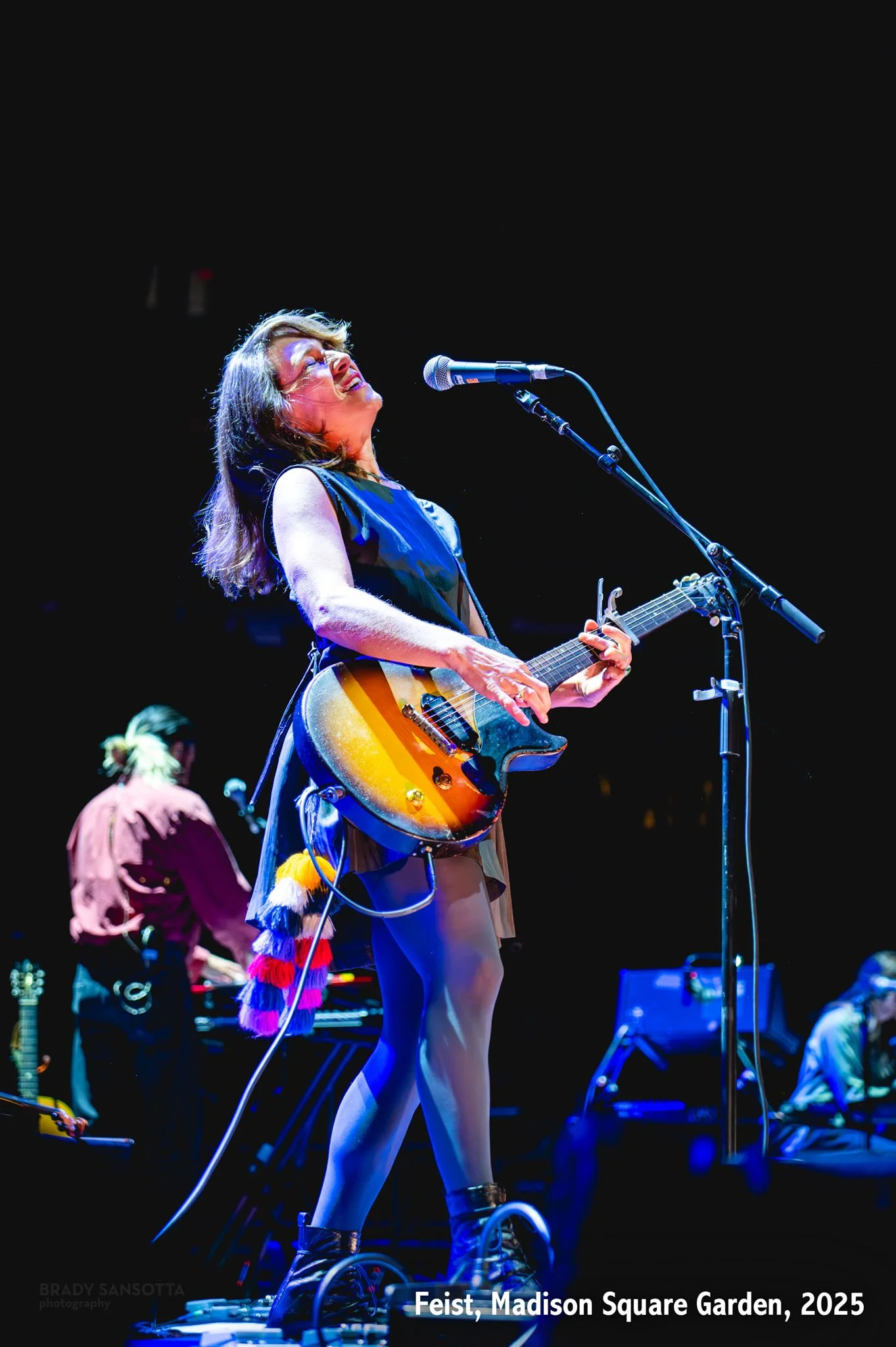 Leslie Feist performing on guitar while opening for The Who at Madison Square Garden in New York City.
