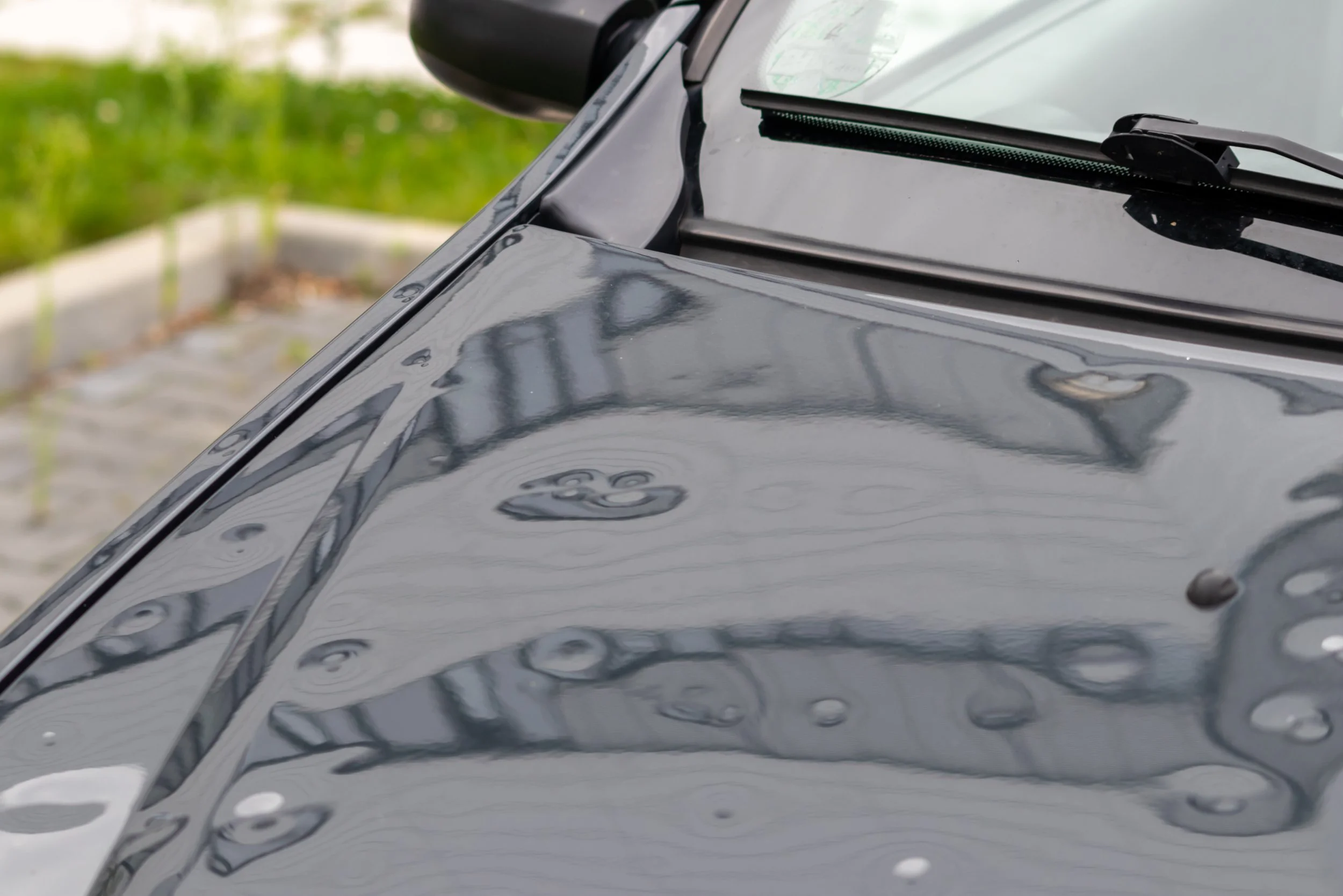 Hail damage on the hood of a black car