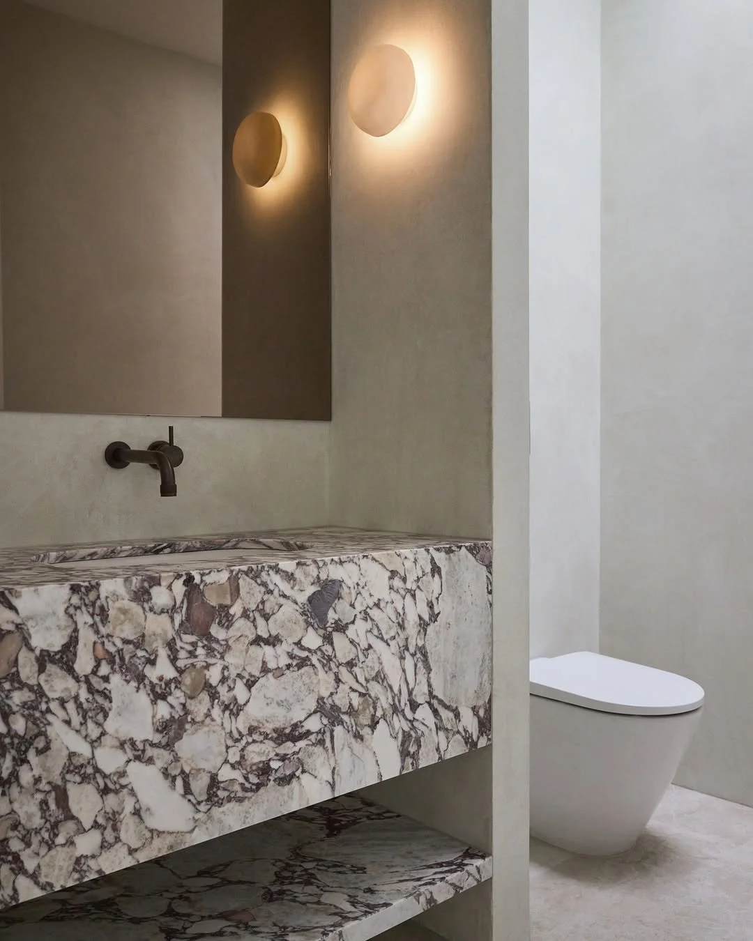 bathroom with x-bond microcement walls in white and viola marble joinery