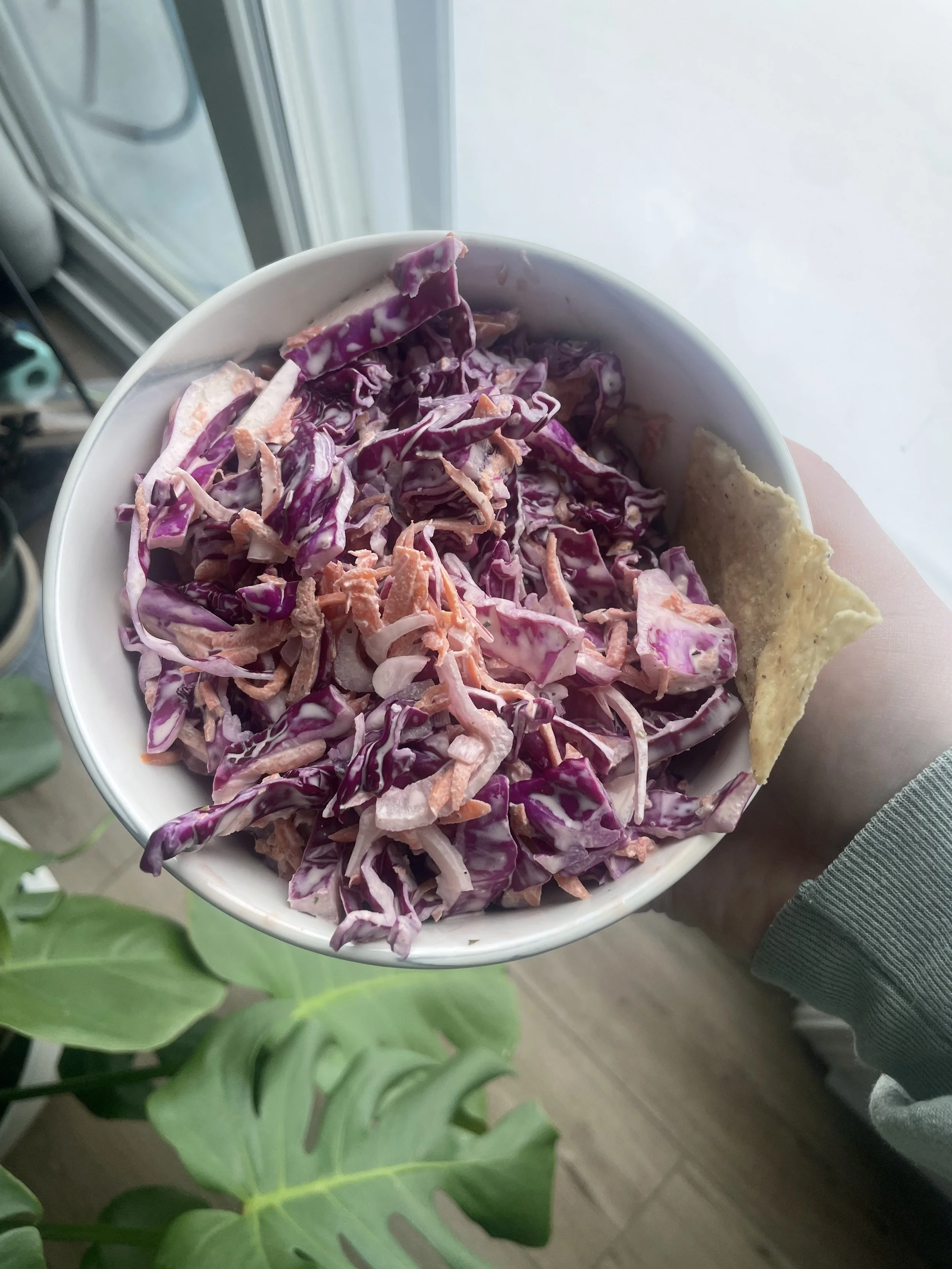 Crunchy coleslaw served in a white bowl