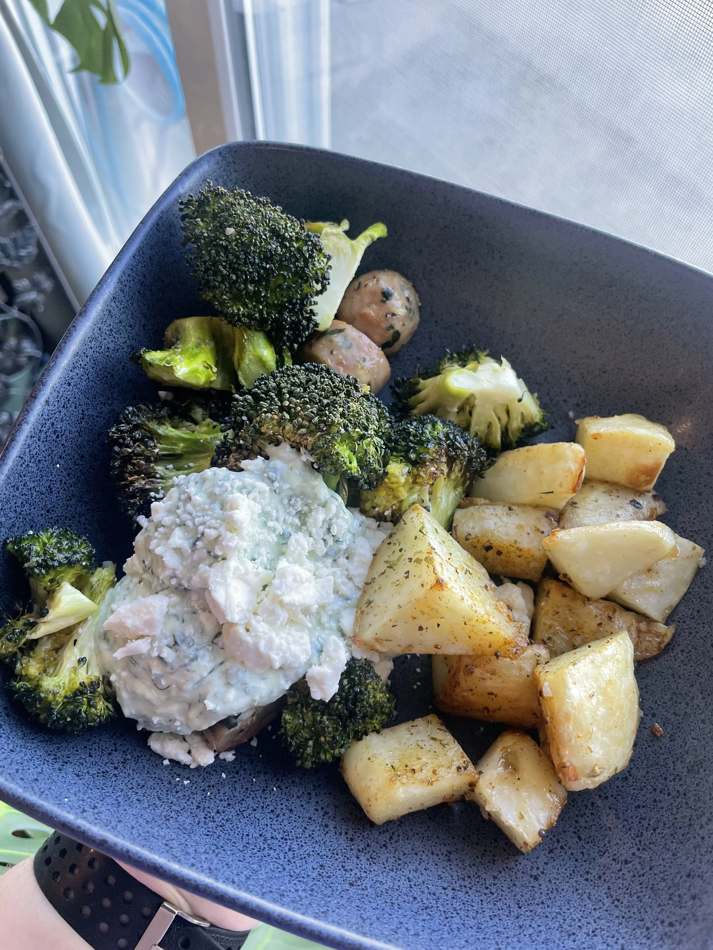 Crispy lemon herb sausage bowl in a black bowl