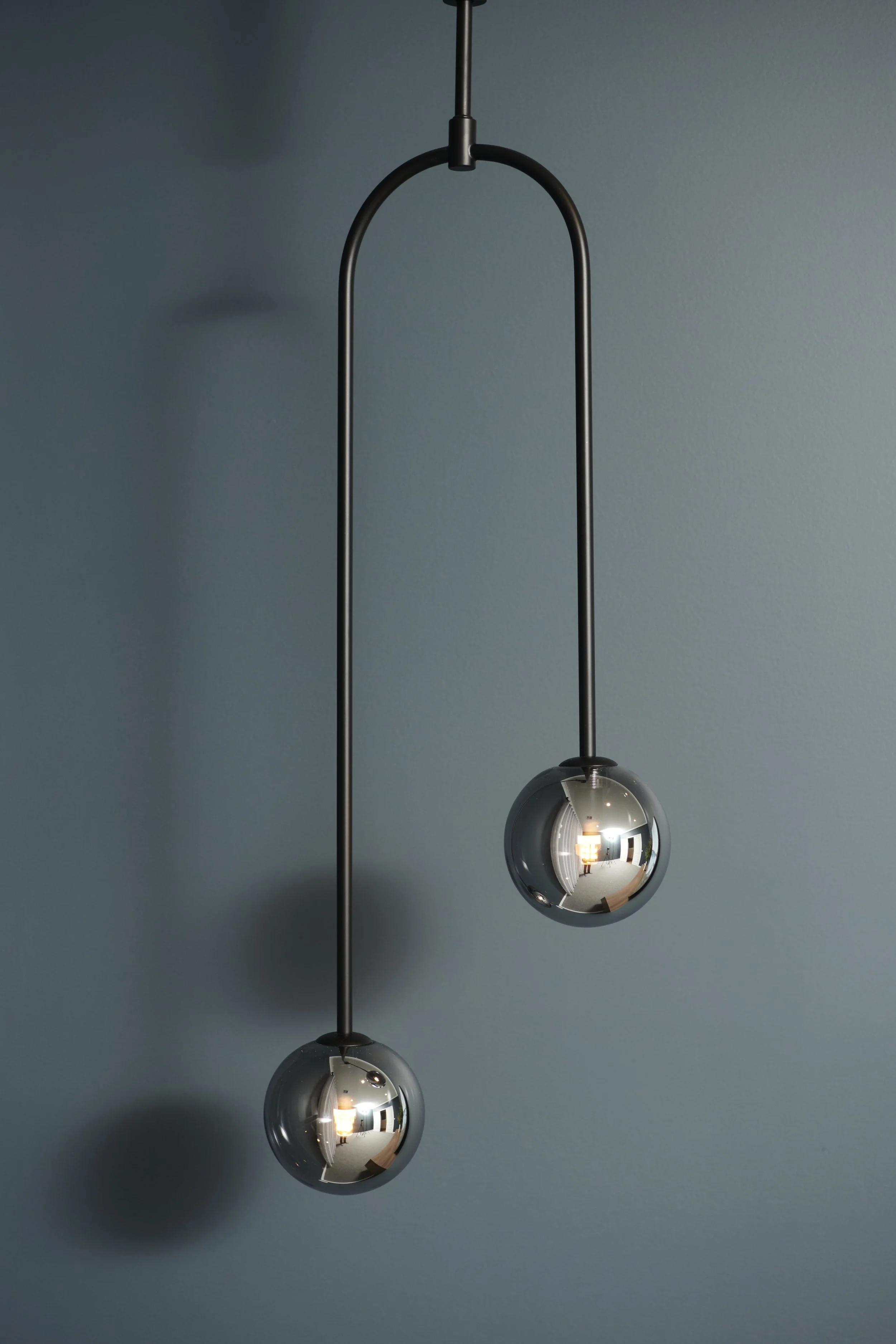 DARK AND MOODY MUSIC ROOM WITH FEATURE GLOBE PENDANT IN THE CORNER OF THE ROOM