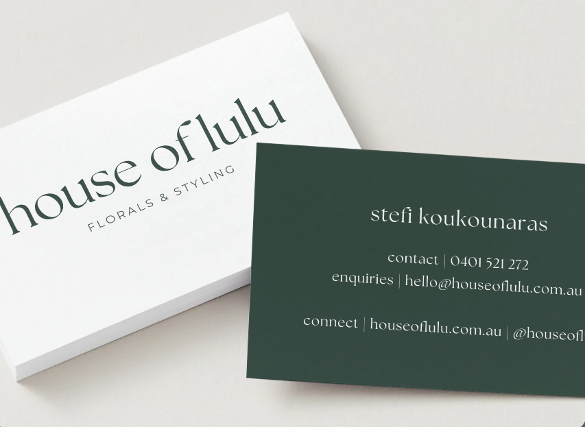 Business cards for 'house of lulu florals & styling' and 'stefi koukounaras' placed on a white surface.