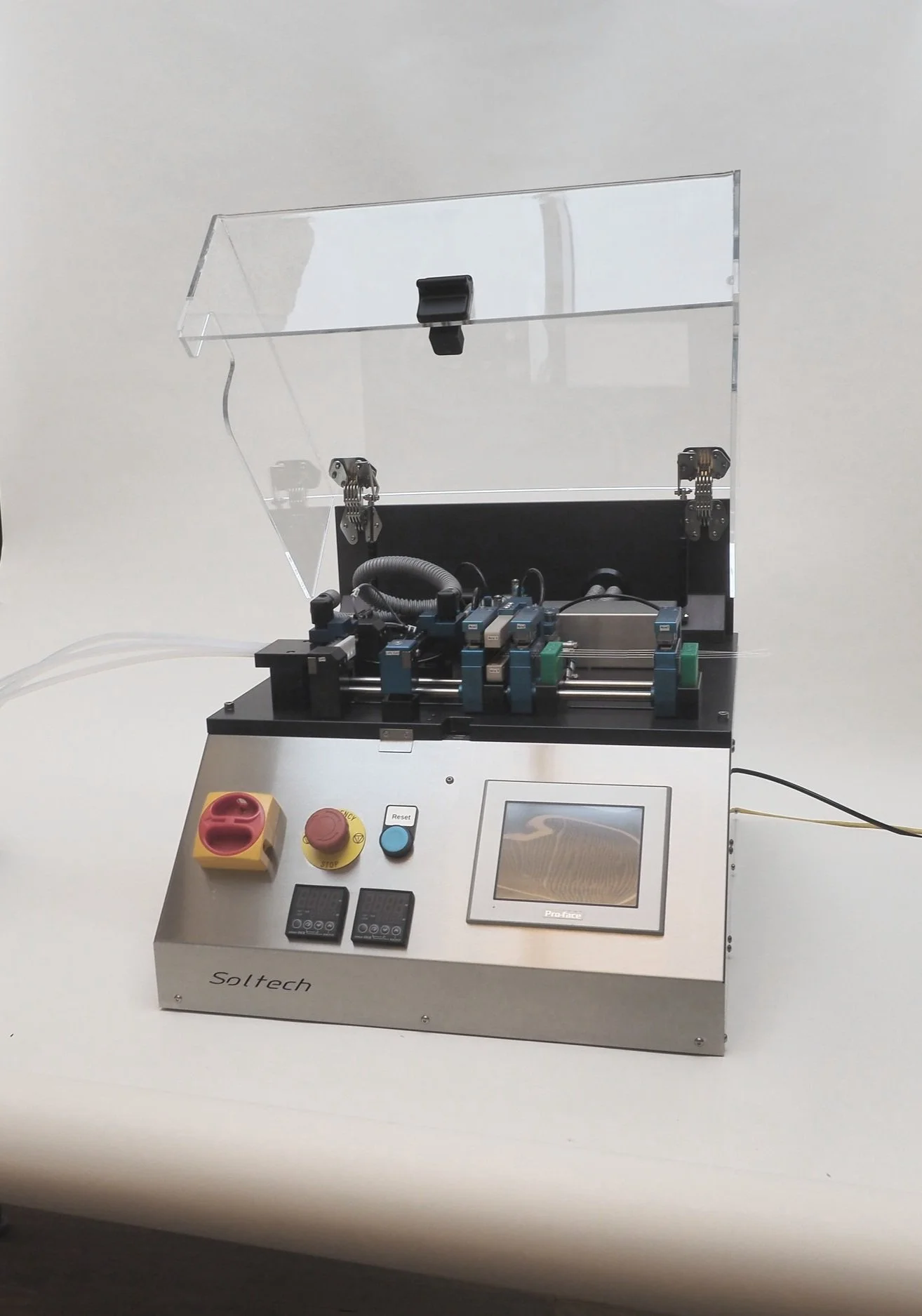 A laboratory machine with buttons, a touchscreen, and mechanical components, branded Soltech.