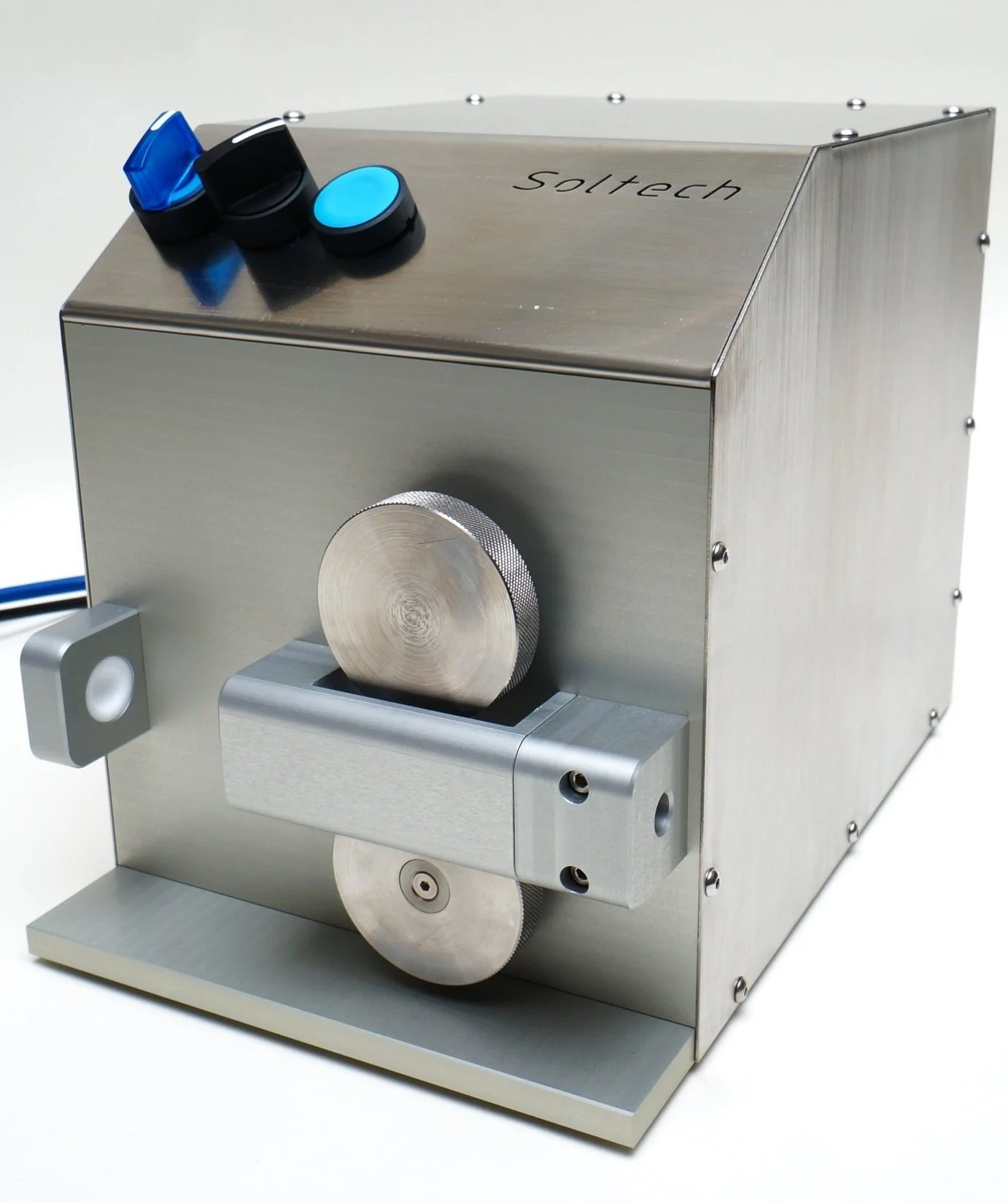 A metallic device with a cylindrical shape and gears, labeled 'Soltech', likely a laboratory instrument or specialized machinery.