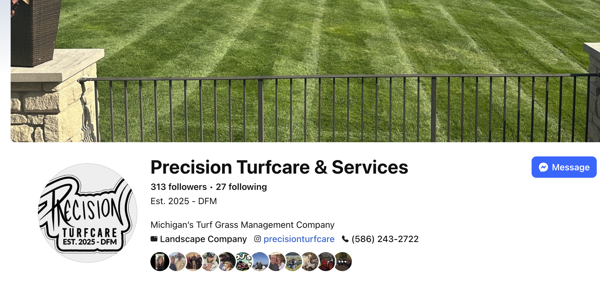 Facebook cover photo of a well-maintained green lawn behind a black metal fence with stone pillars on either side.