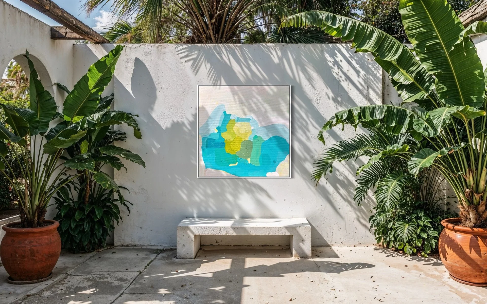 Minimalist museum quality canvas print Ocean Retreat by Birgit Trofer styled on an outdoor concrete wall with a concrete bench, palm trees, and beautiful natural sunlight.