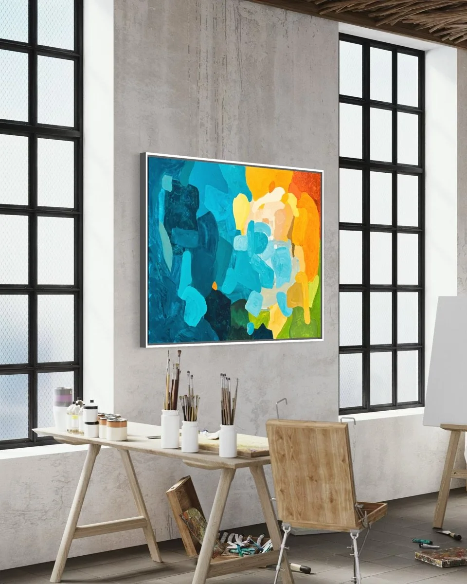 Side view of original artwork Sunset Flow by painter Birgit Trofer inside a loft studio, surrounded by artist brushes and rich color pigments.